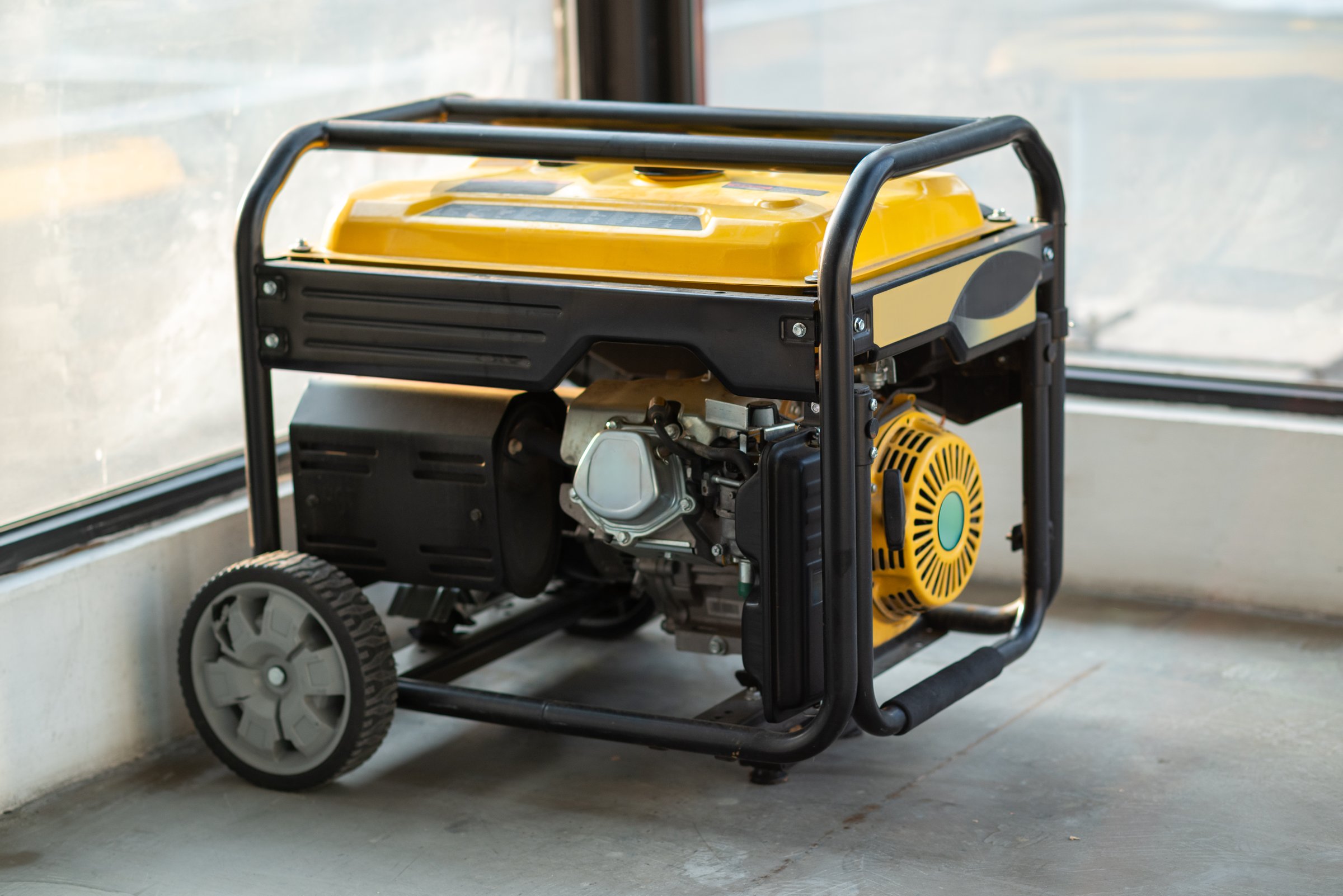 Portable electric generator running in the cold winter.Energy genocide. Small business use gasoline generators
