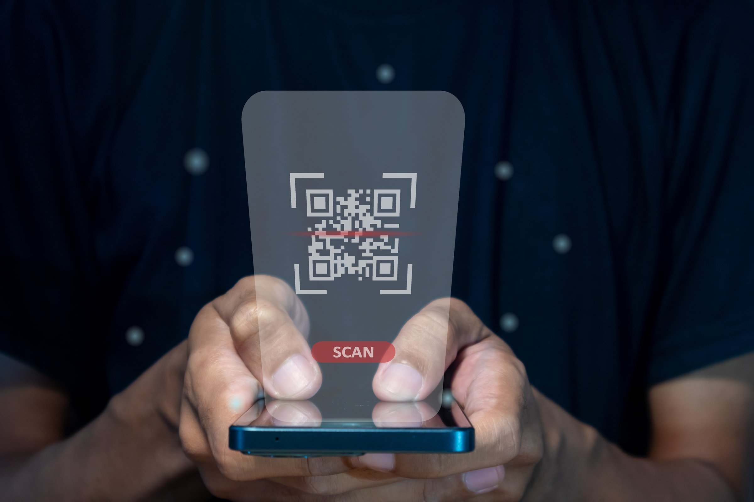 Male hand using a smart phone to scan QR code. QR code payment, registration, E-wallet or cashless technology concept.