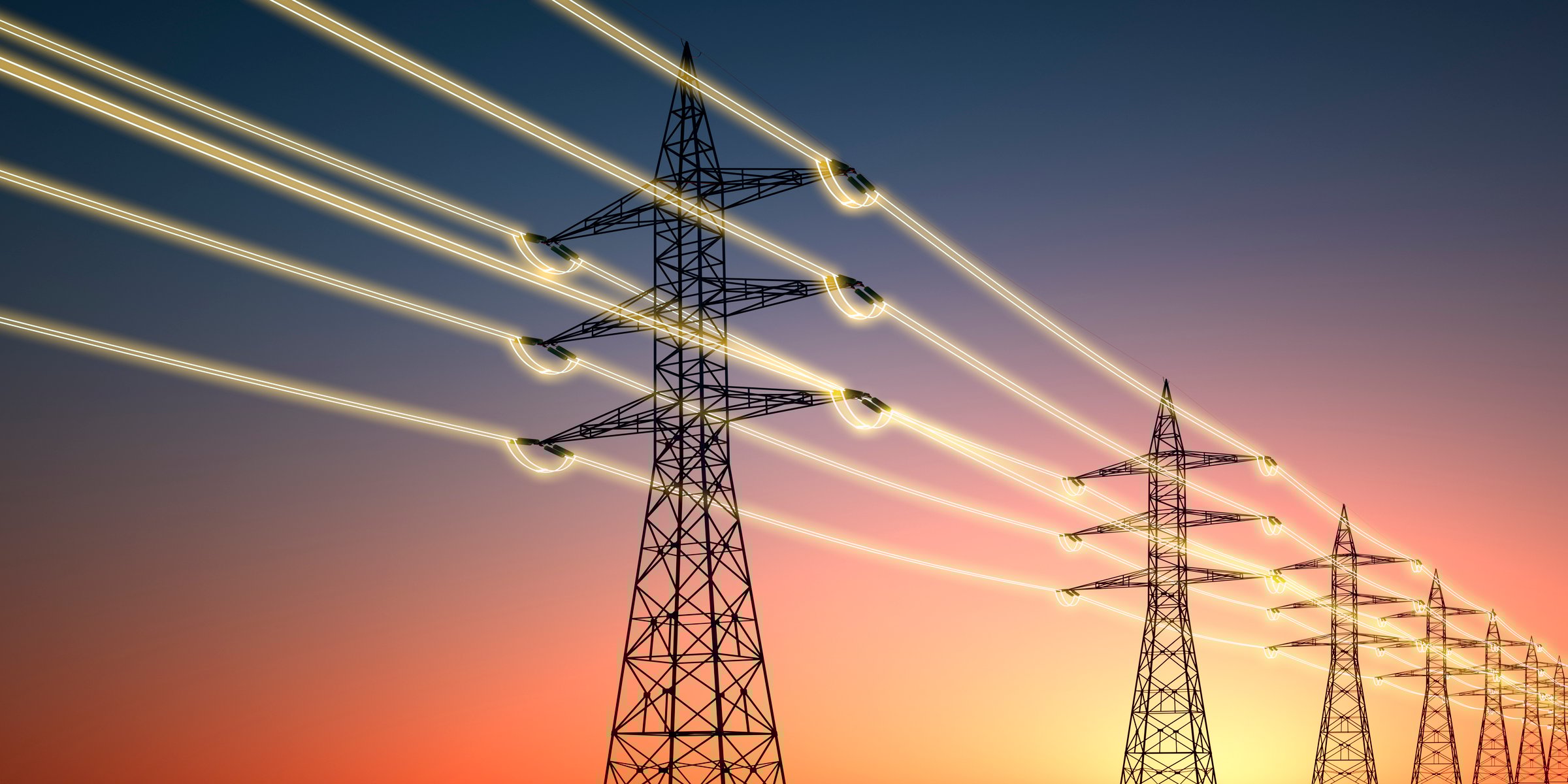 Electricity transmission towers with glowing wires against sunset sky - Energy concept