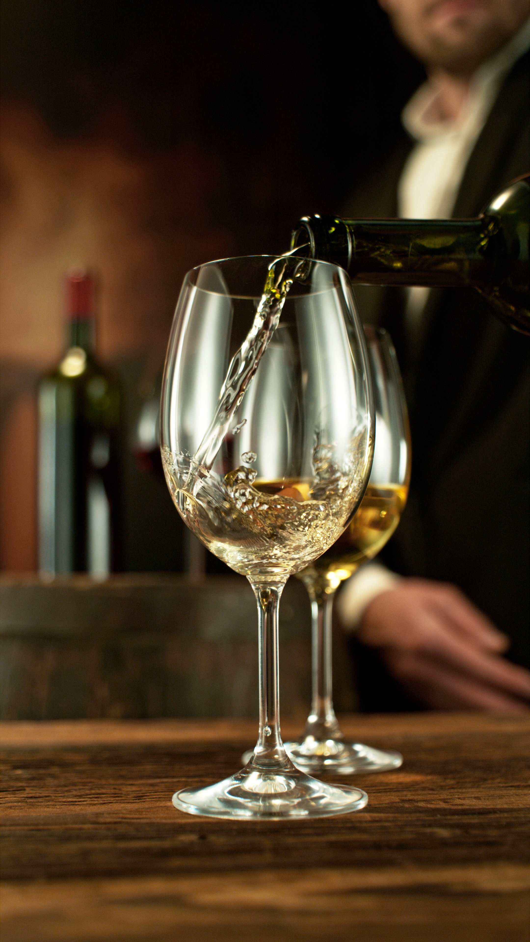 Detail of White Wine Pouring. Wine Cellar on Background.Detail of White Wine Pouring. Wine Cellar on Background.Detail of Red Wine Pouring. Wine Cellar on Background.