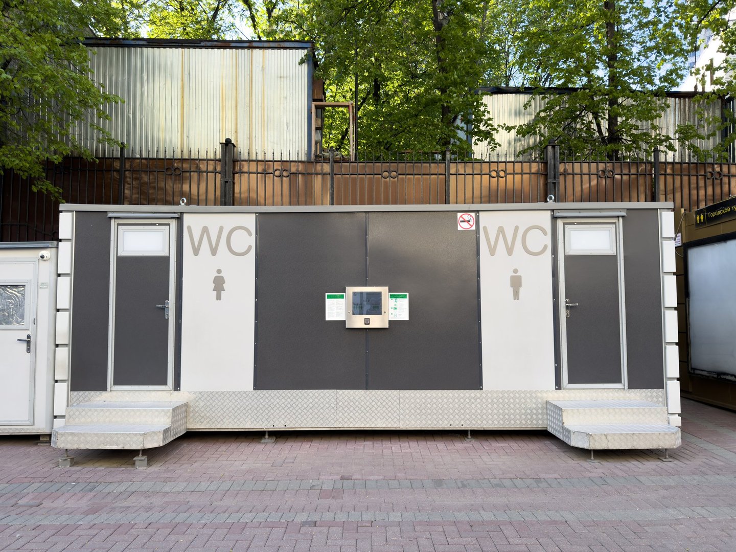 Moscow, Russia, April 26, 2025: Public self service toilet station with touch panel and separate entrances for men and women located outdoors in an urban environment