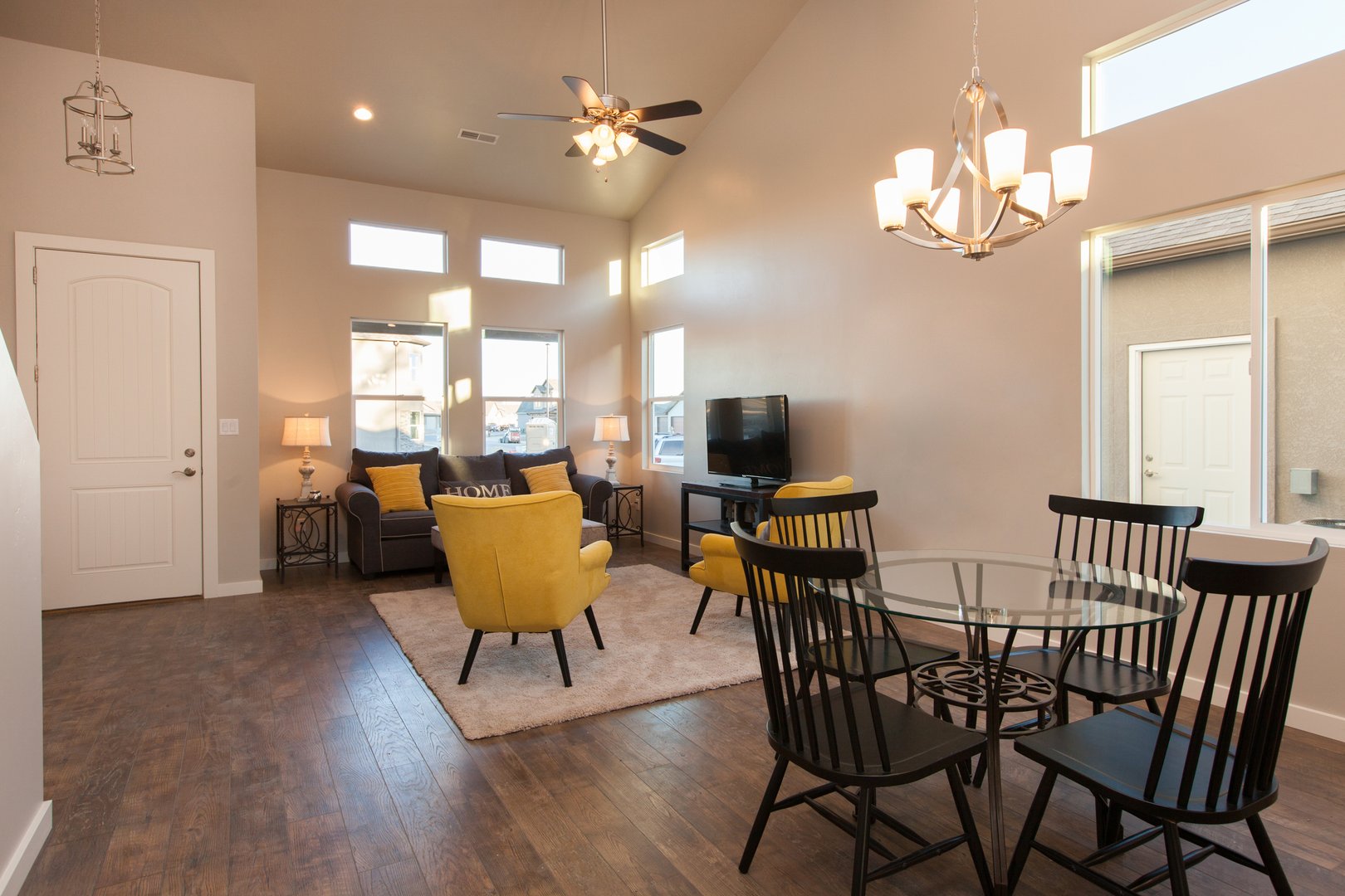 Modern interior new home dining room looking into living room with wood floors fully furnished real estate listing