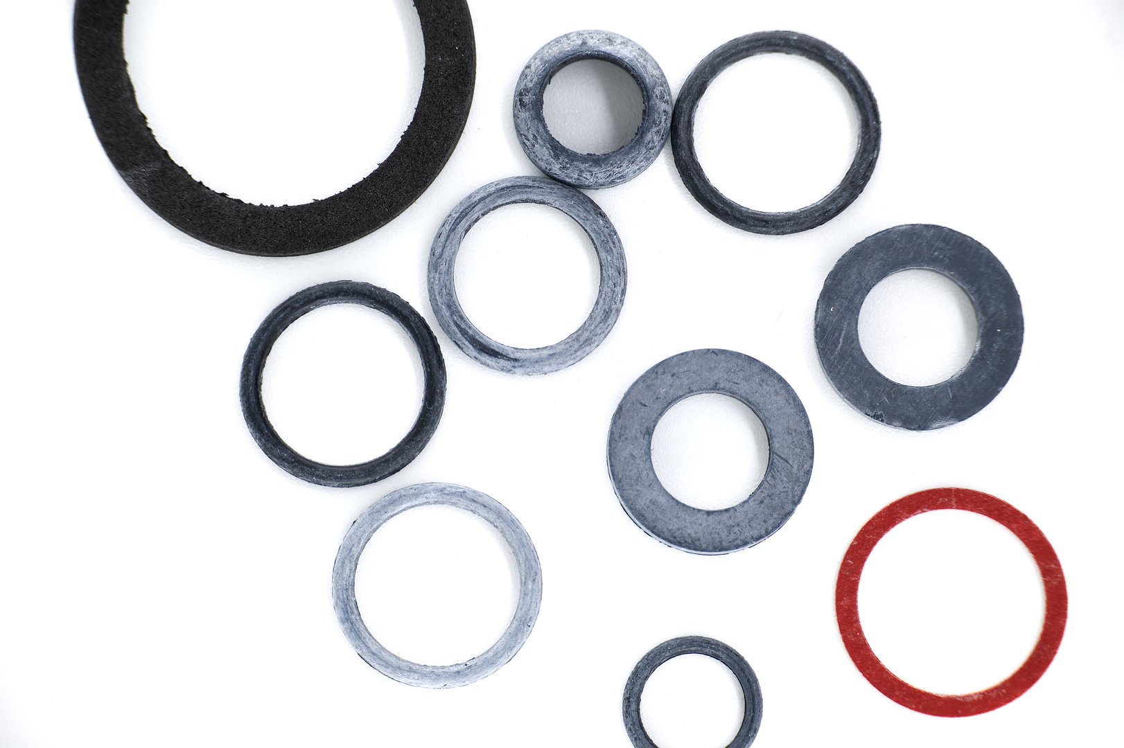 A collection of various rubber and gasket rings, showcasing different sizes and materials, with a white background.