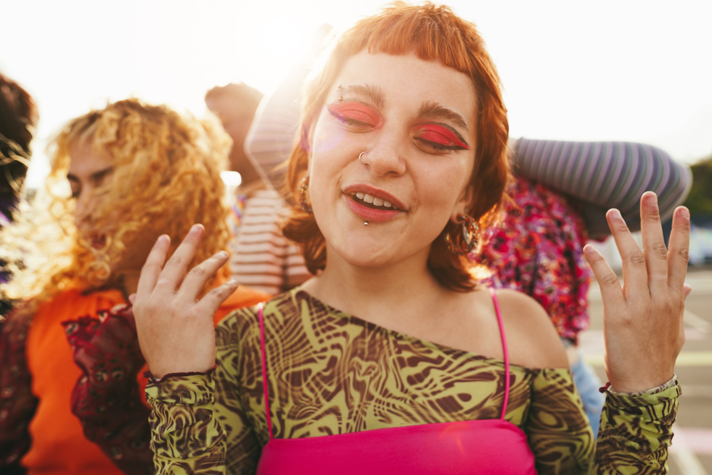 Young diverse people having fun outdoor laughing together - Soft focus on girl nose
