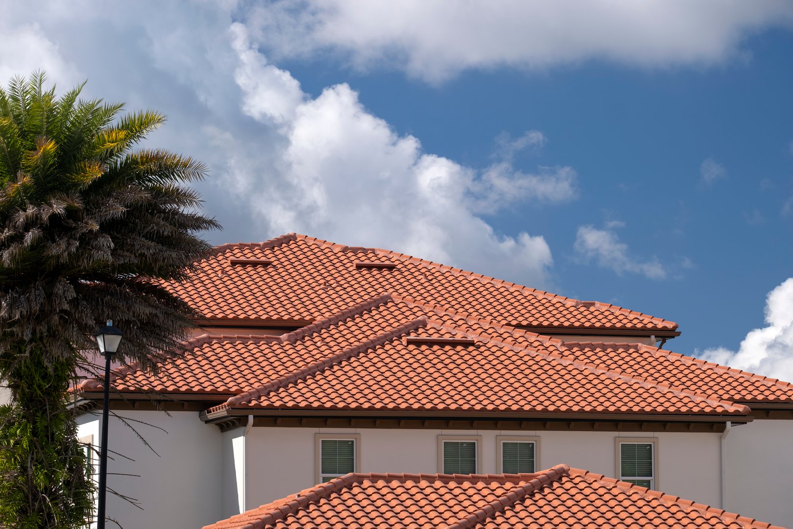 Closeup of house rooftop covered with ceramic shingles