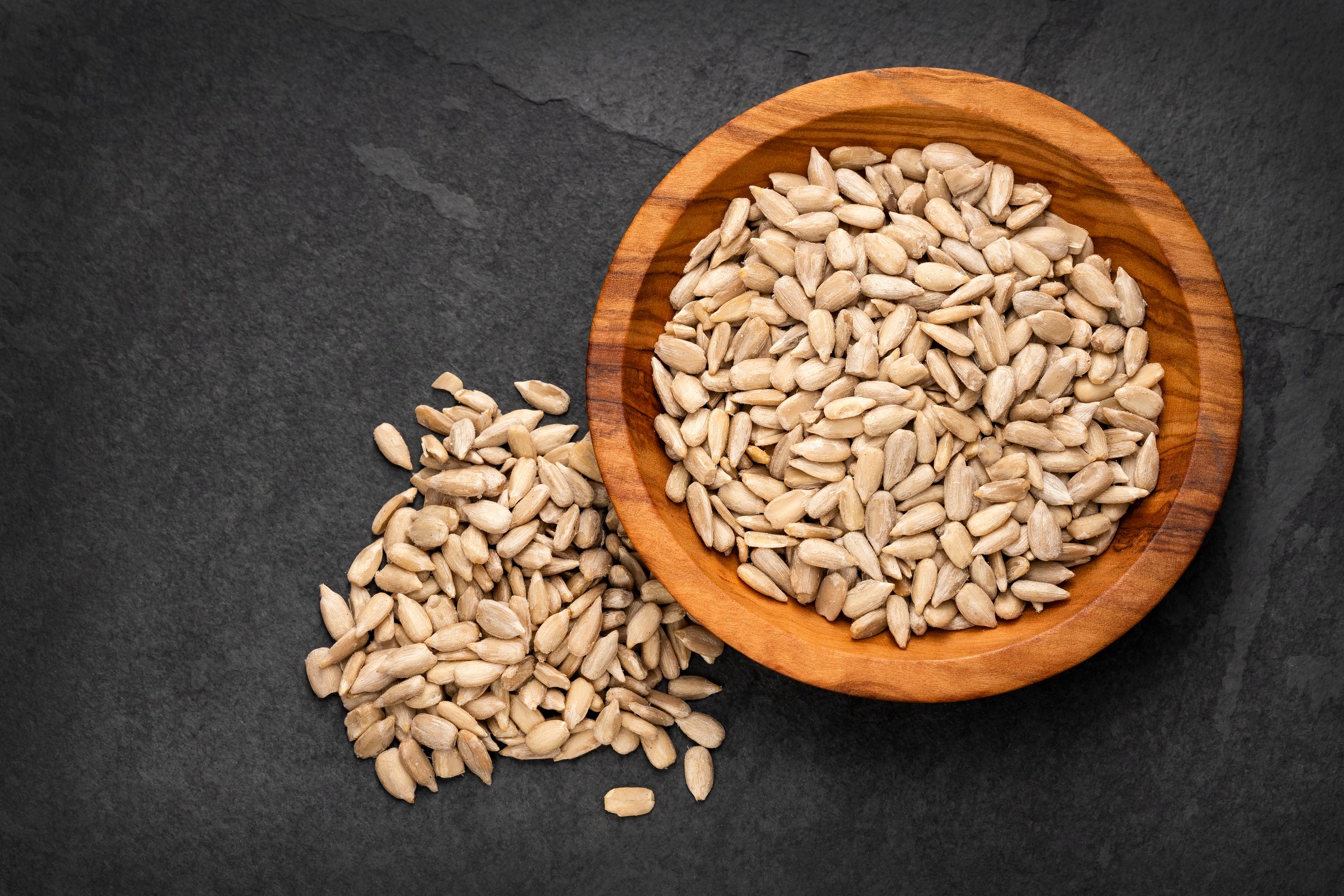 Helianthus annuus - Shelled sunflower seeds in bowl.