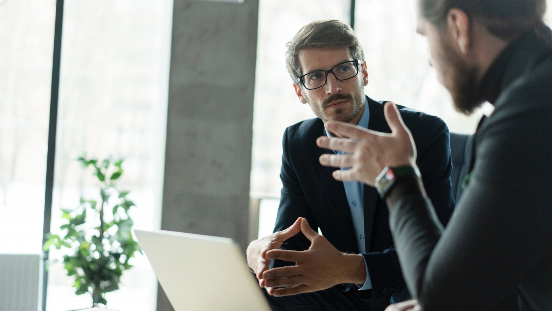 Businessmen discussing deal, sharing startup ideas, business partners negotiations or job interview in modern office, colleagues talking, working on project together