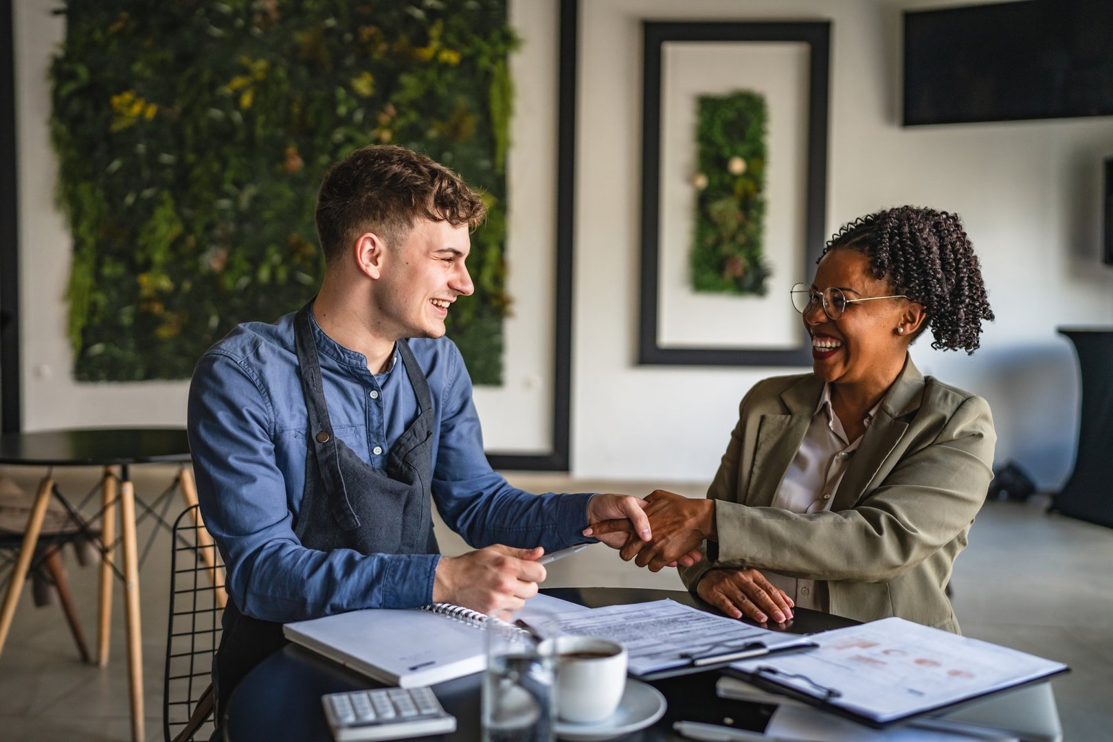 young man entrepreneur handshake with female financial adviser