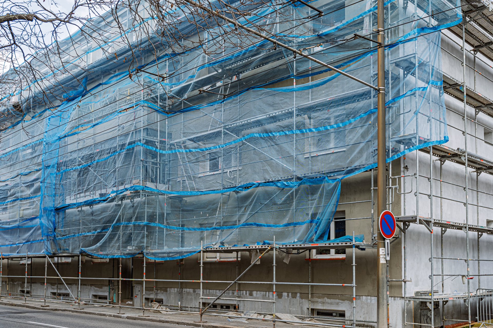 Scaffolding on an old house, renovated historical building facade detail. Restoration industry, old architecture, real estate renovation simple concept, no people