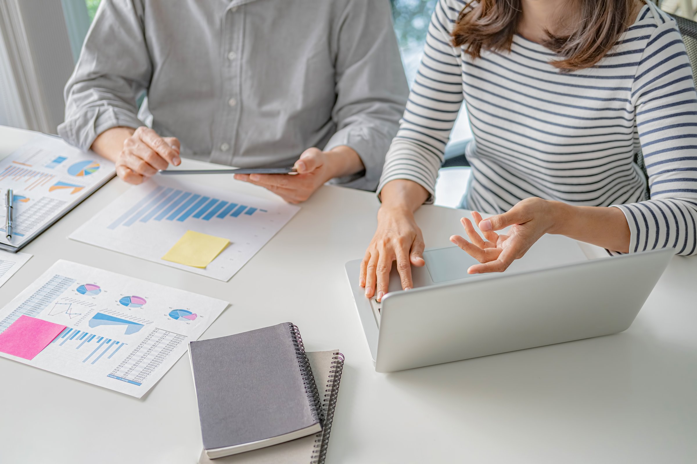 Professional investor working with new startup project. Digital tablet laptop computer design smart phone in office.