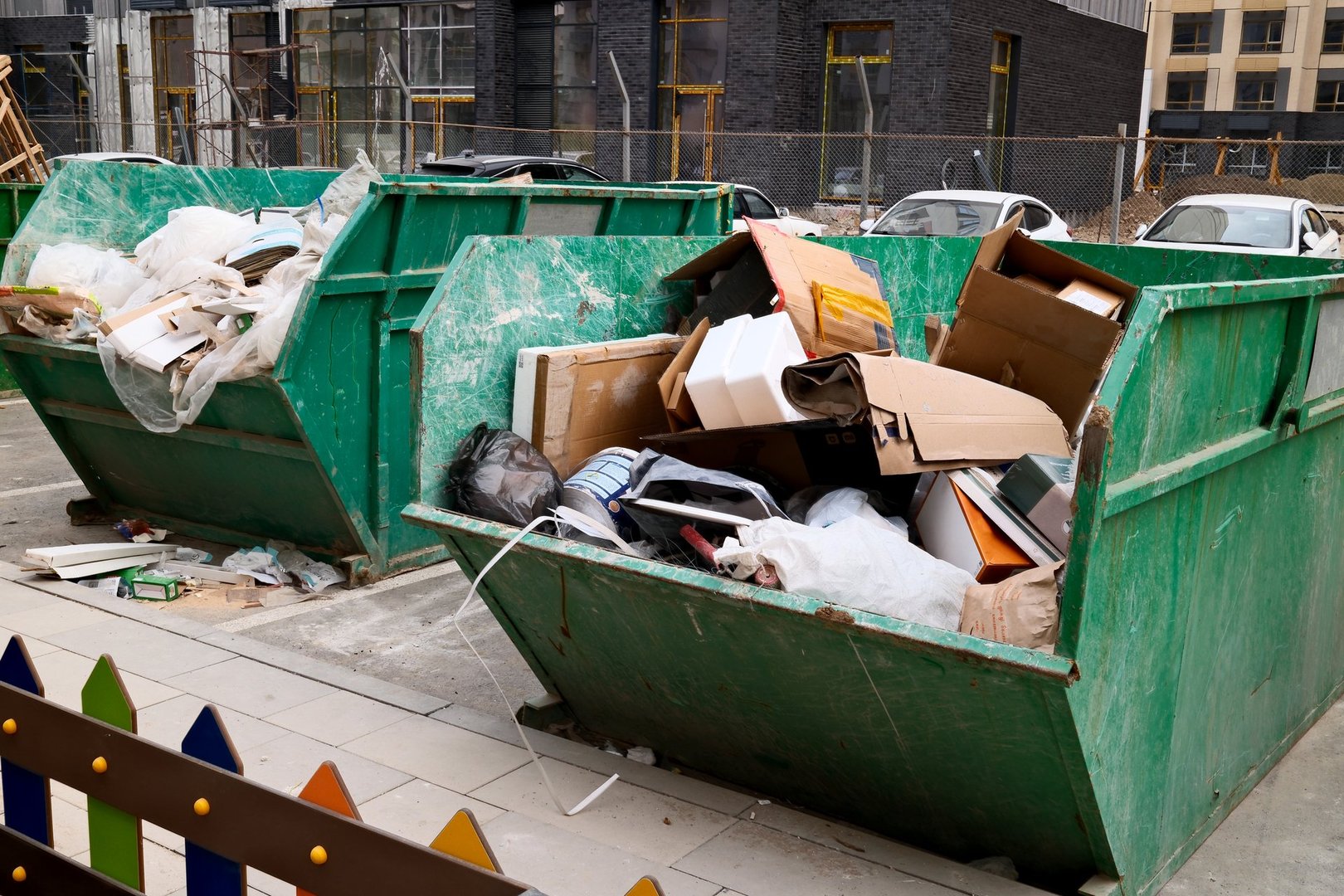 Dumpster with construction waste at urban construction site