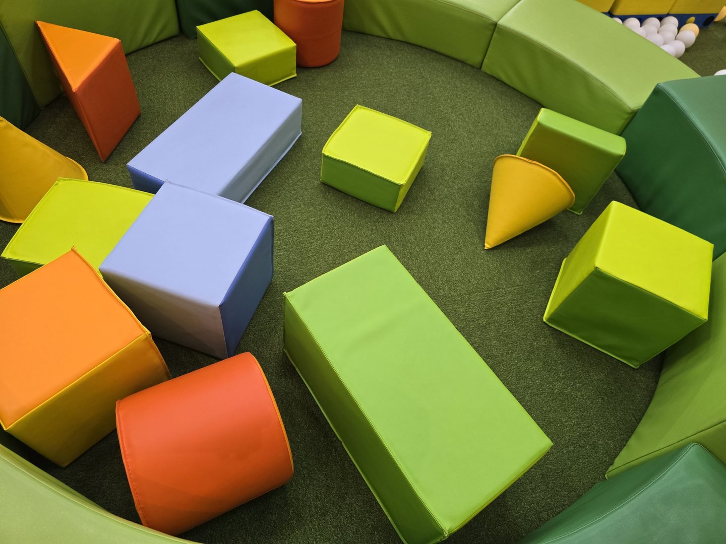 Bright and colorful foam shapes in a safe play area designed for young children. Ideal for promoting creativity, learning, and motor skills development.