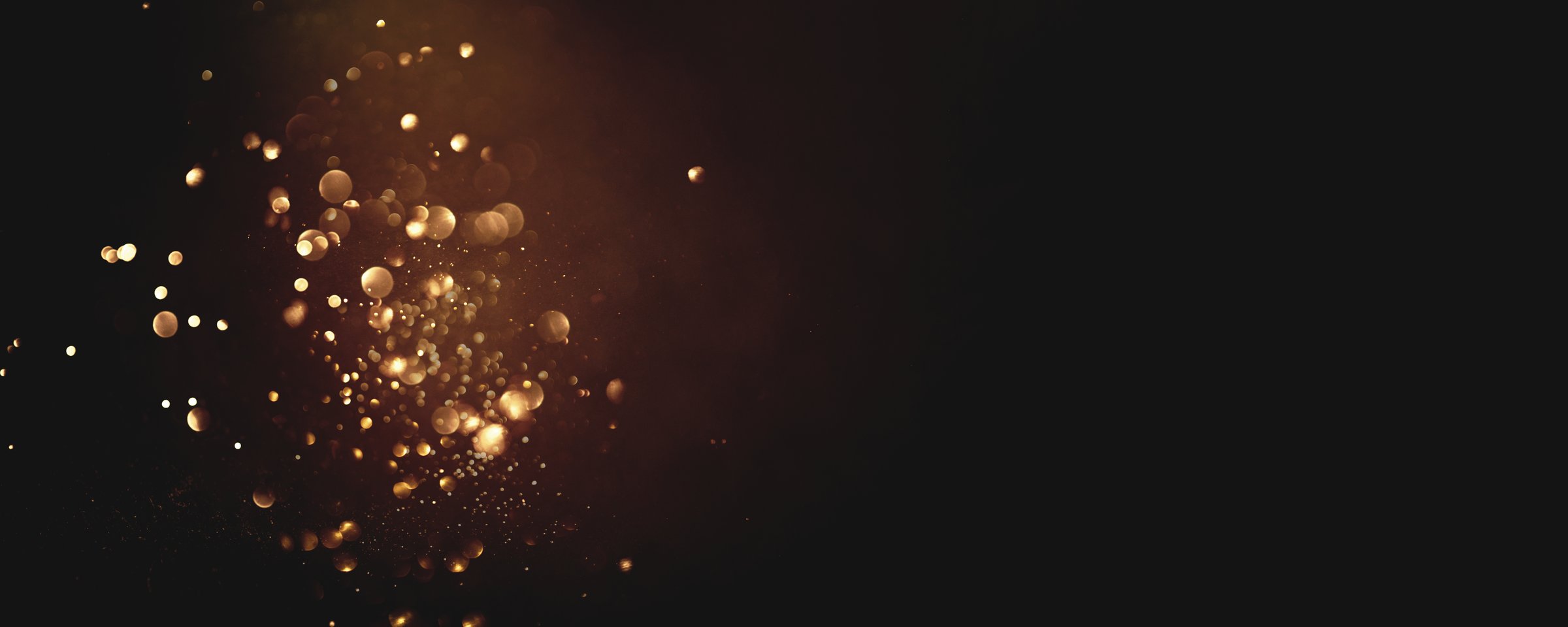 Golden abstract bokeh on black background