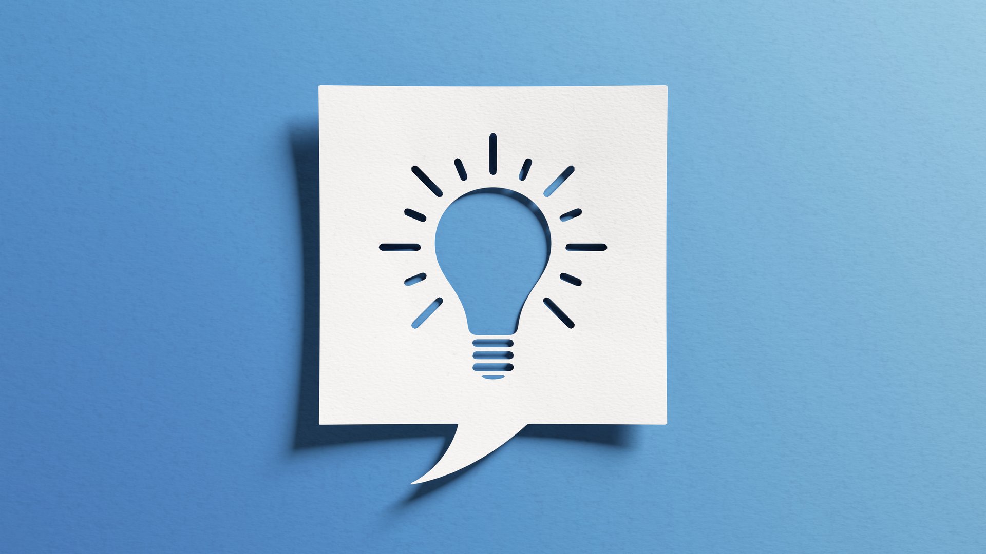 Innovation and idea symbol with light bulb shape. Concept about creativity, invention, innovative solutions for business communication. White cutout paper over blue background.