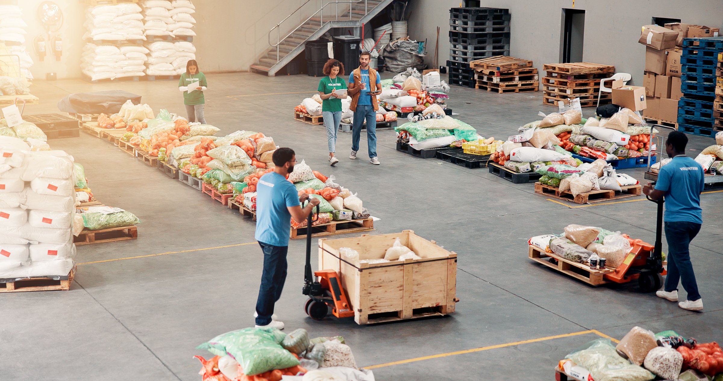 People, volunteer and grocery distribution at warehouse, community charity and humanitarian aid. Staff, help and machine courier for food stock of ngo services, homeless donation and parcel logistics