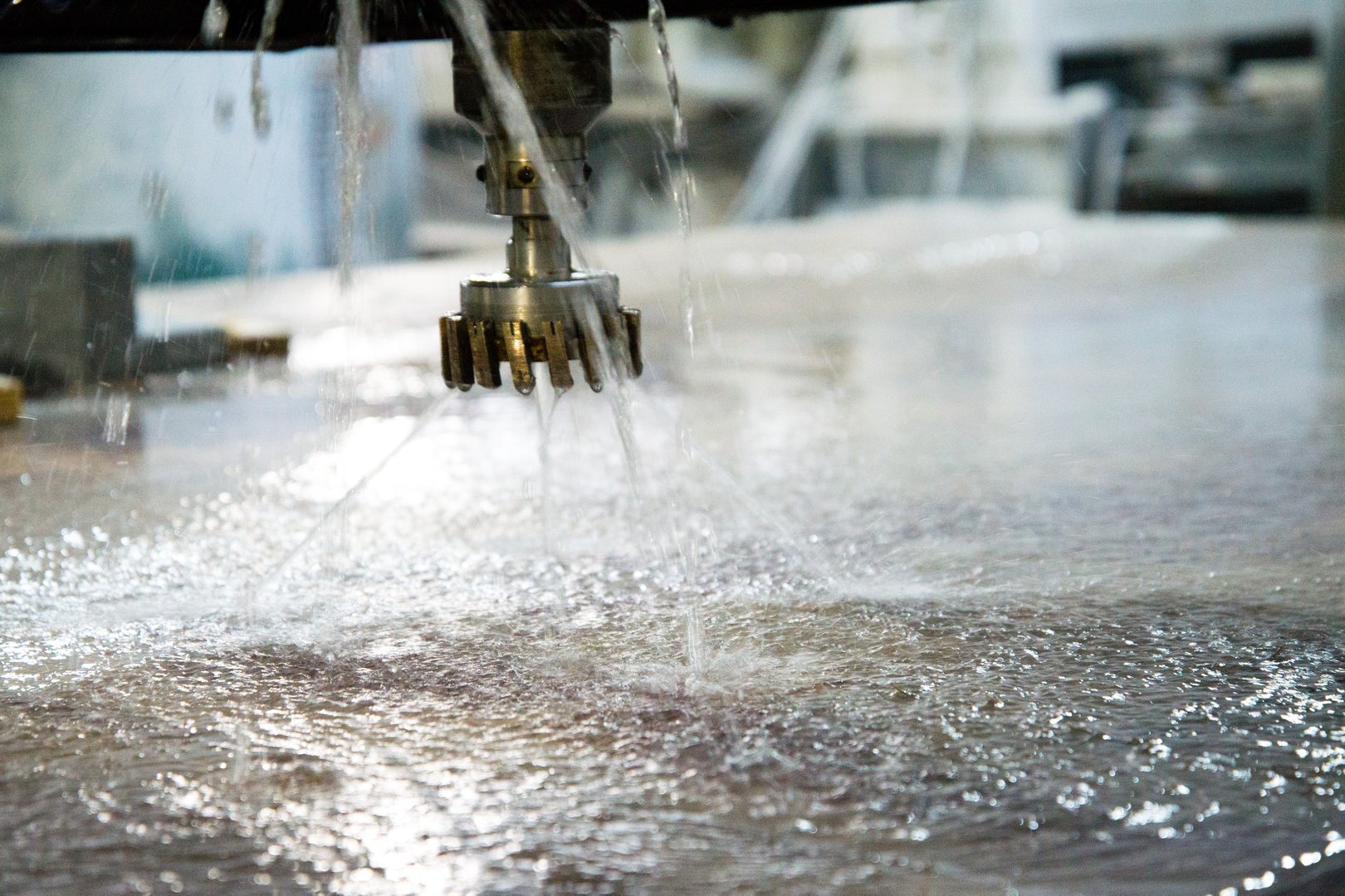 Cutter close-up. Jets of water. Machine for industrial processing of stone. Ready for work.