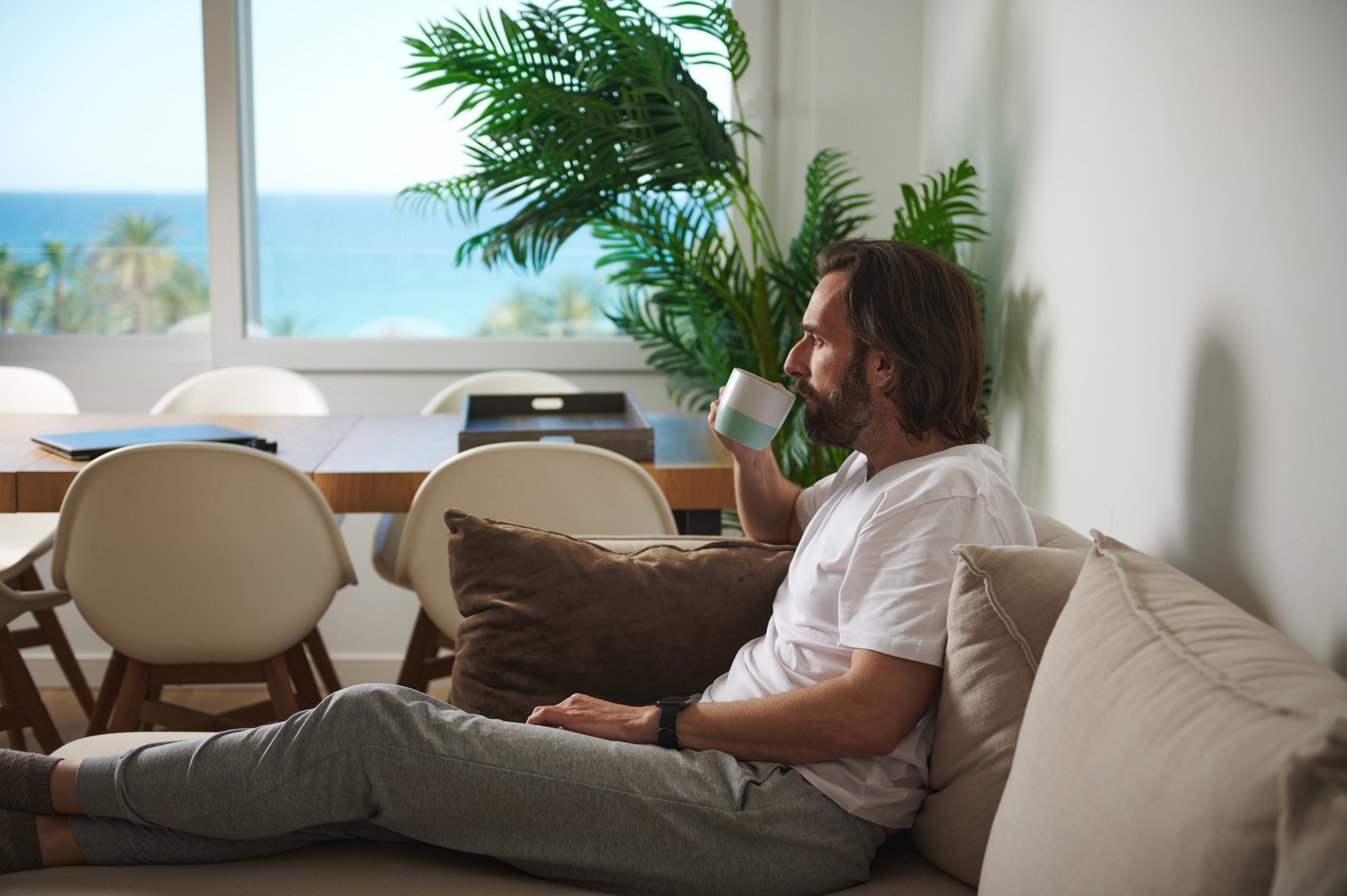 Man enjoying coffee with coastal view