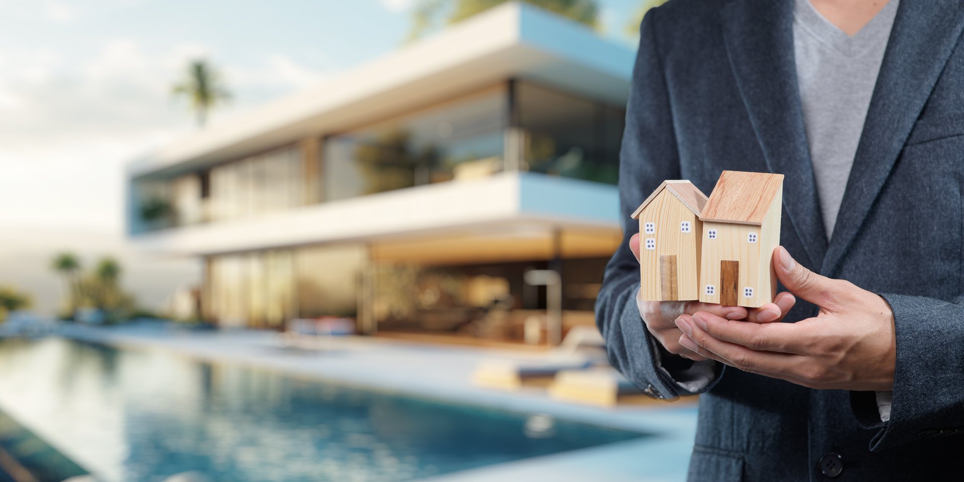 A professional individual presents model houses near a stunning luxury home, showcasing elements of real estate sales, business strategy, and modern design.