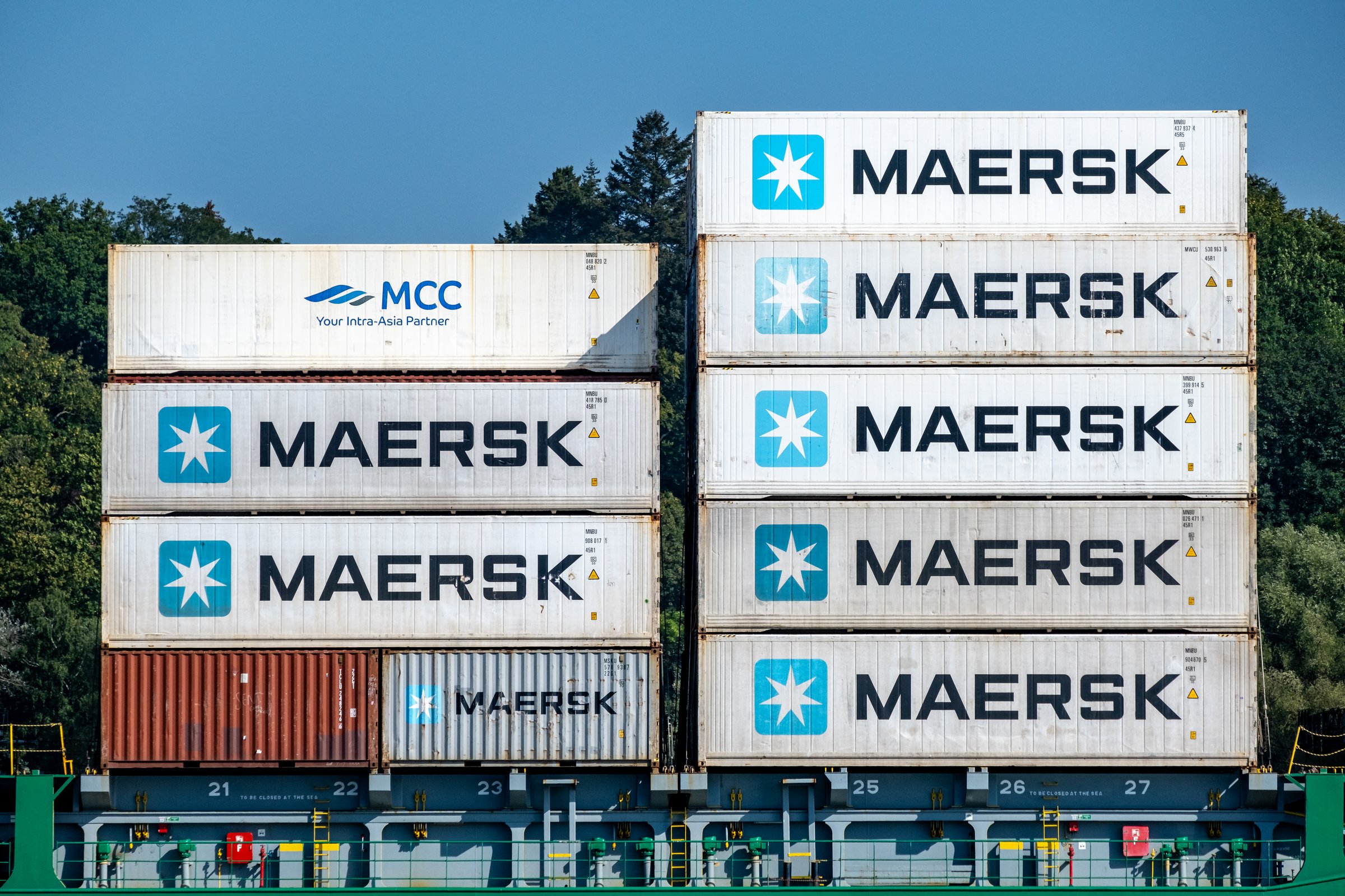 Hamburg, Germany - 09 05 2024: close-up of various stacked containers, mainly from Maersk