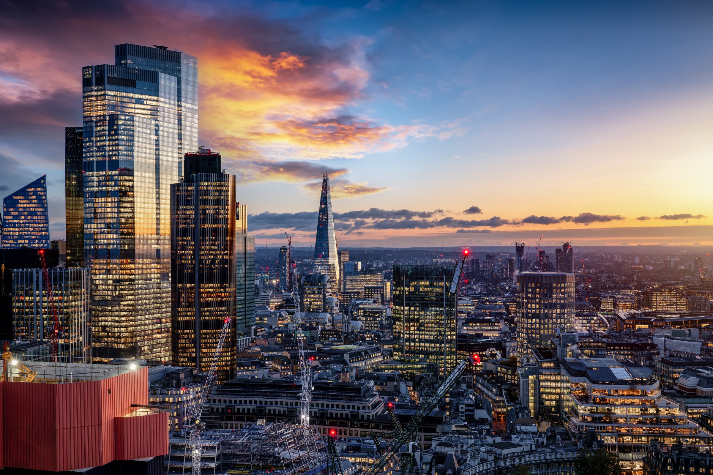 The illuminated skyline of London from the City skyscrapers to Elephant and Castle and Southwark during dusk time
