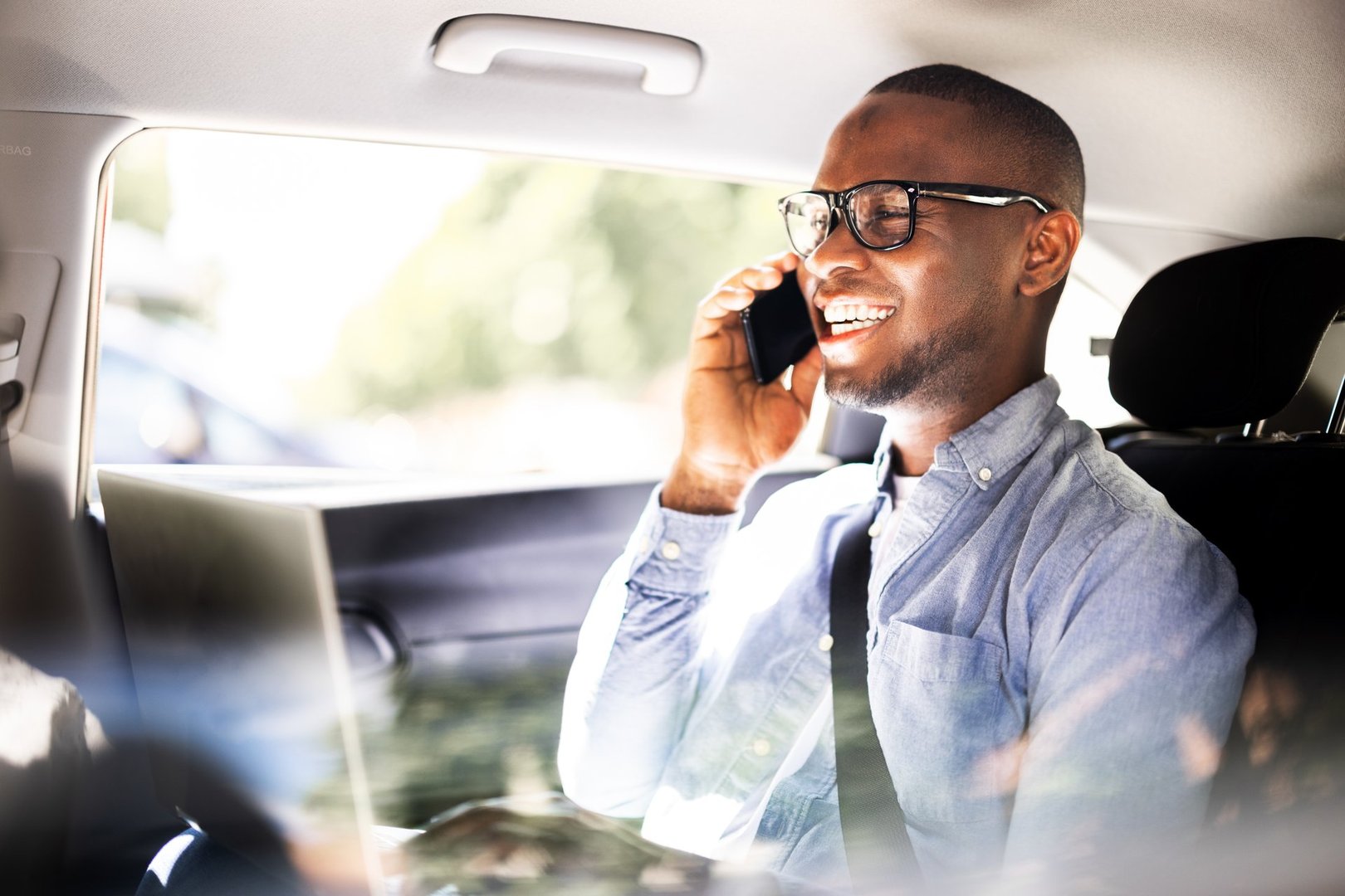 Luxury Taxi Conversation: African CEO and American Executive Discuss Global Business Ventures While Traveling in Style with Technology.