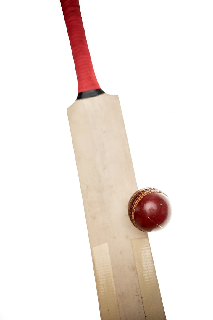 Cricket bat hitting ball in isolated white background