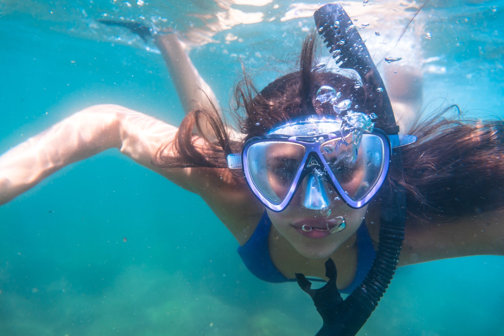 Teenager girl snorkeling in the ocean, discovering vibrant underwater marine life while enjoying the beauty of a tropical paradise