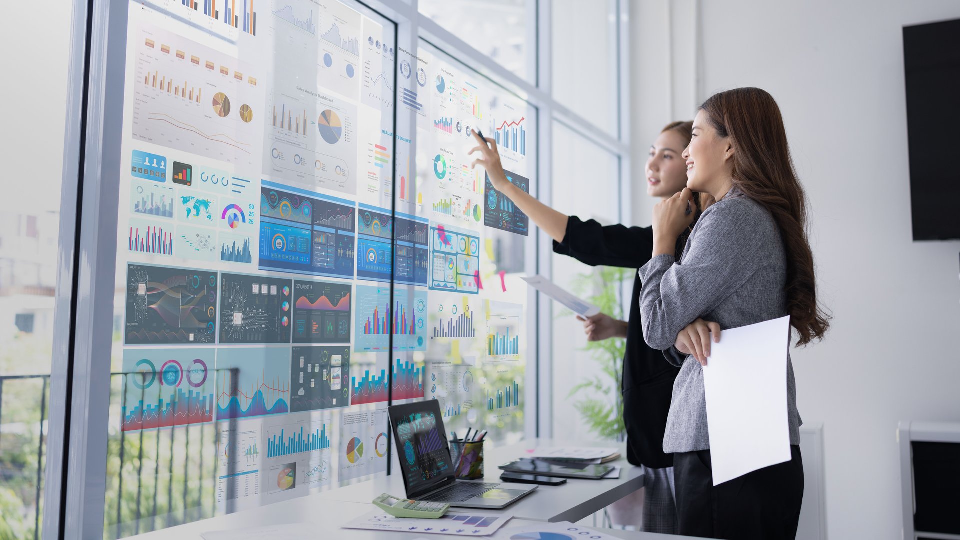 Two businesswoman presentation with marketing strategy analysis at meeting room, Business technology in boardroom for training marketing concept.