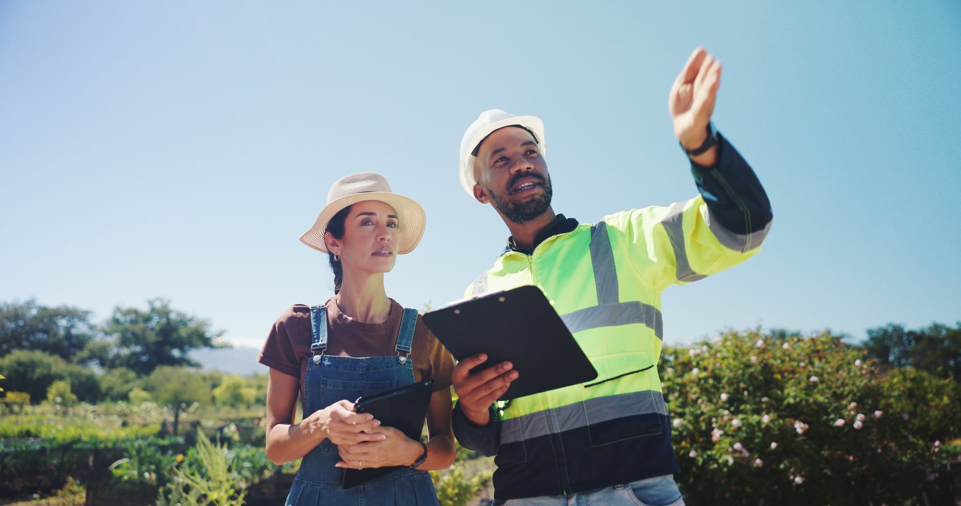 People, agricultural engineer and farmer on farm for irrigation system project, environment sustainability and planning. Water management, talking or clipboard checklist for biodiversity conservation