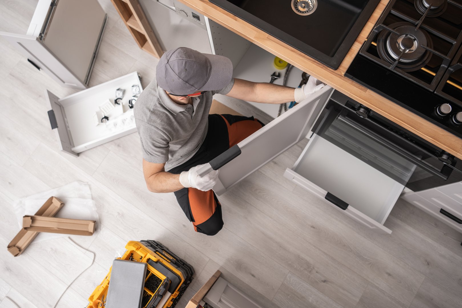 Professional Kitchen Cabinetmaker Installing Furniture Inside a Apartment