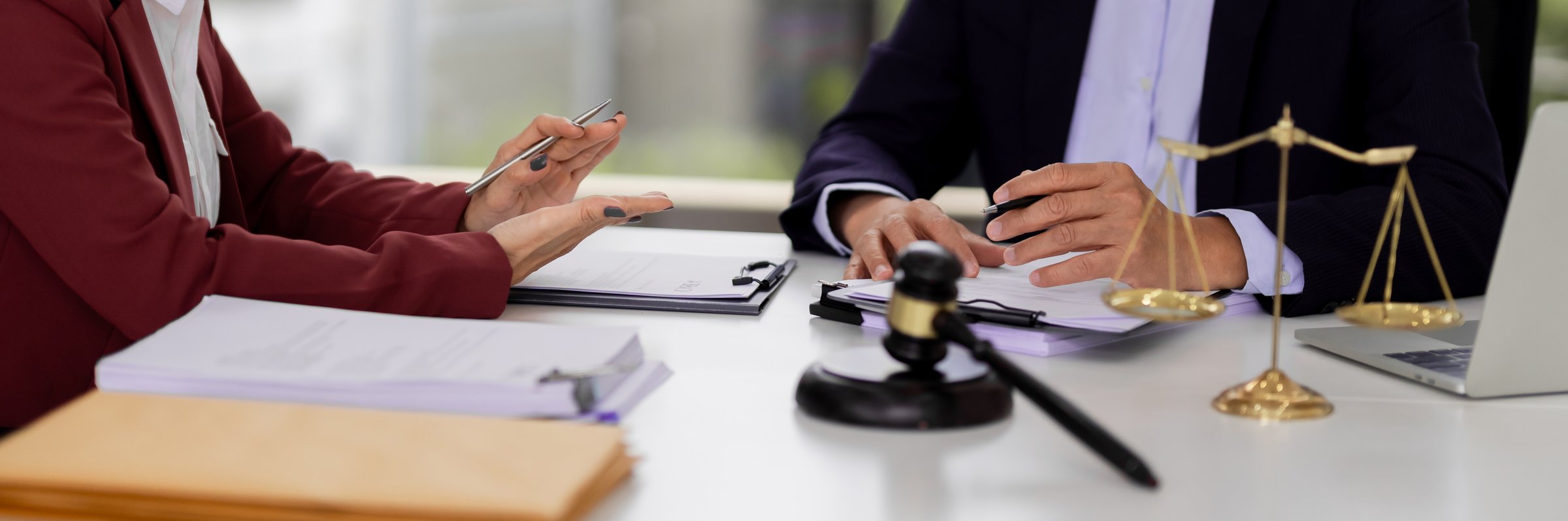 Adult Asian legal professionals hands advise discuss complex legal documents justice office environment. Expert lawyer guidance client meeting.