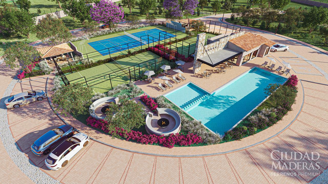 Aerial view of a recreational area with a pool, sports courts, lounge chairs, shaded areas, and surrounding greenery.