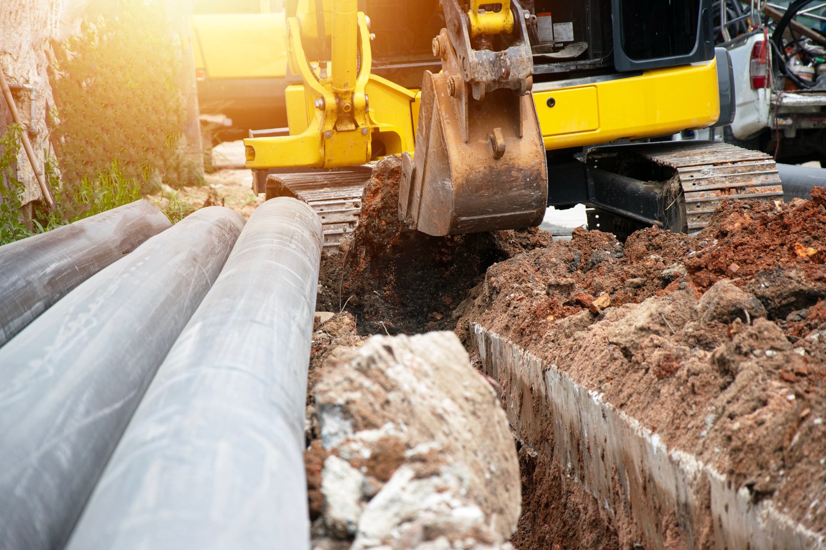 A mini excavator is working on a construction site.