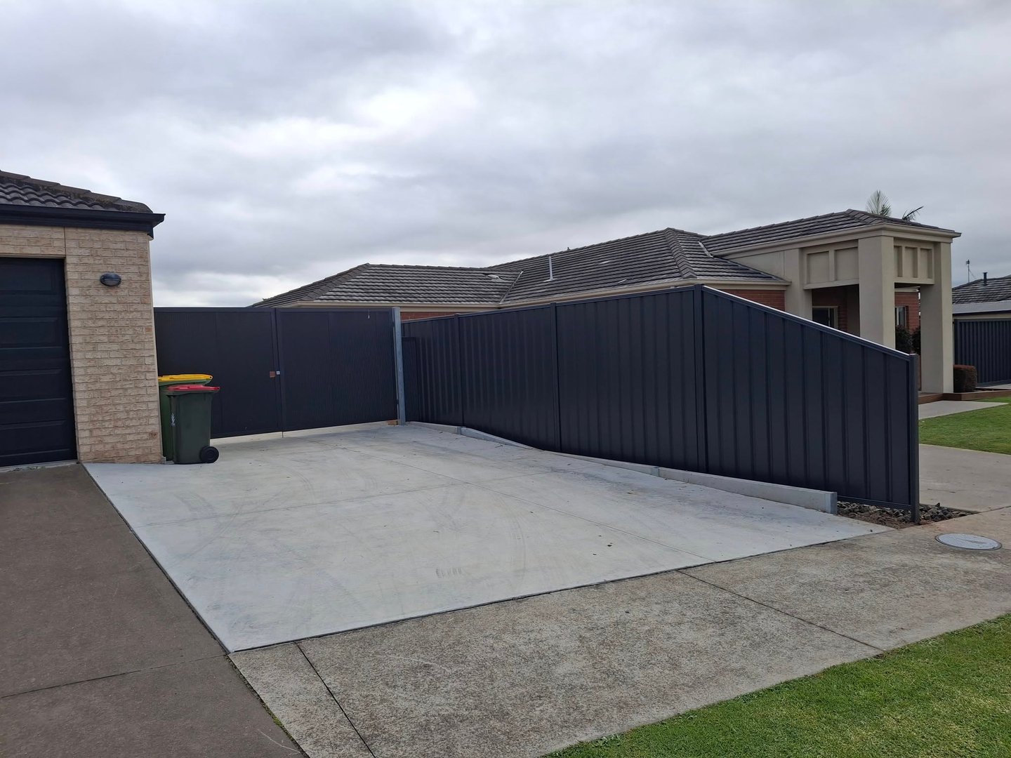 Carpenter repairing wooden fence