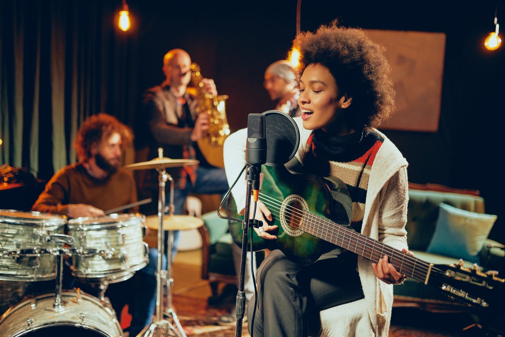 Woman singer in a professional music studio with a band