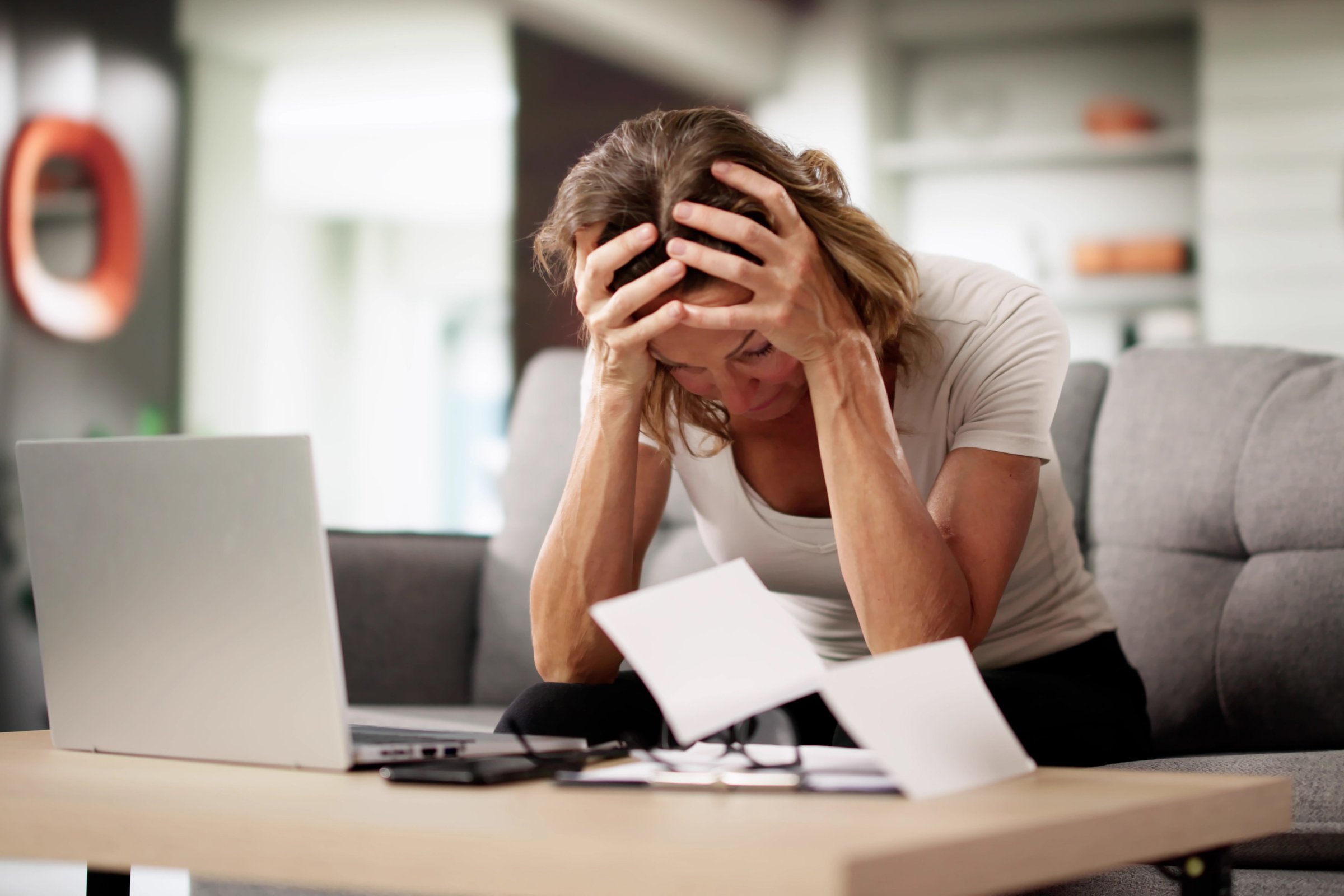 Worried Businesswoman Examining Shocking Invoice With Stress And Concern