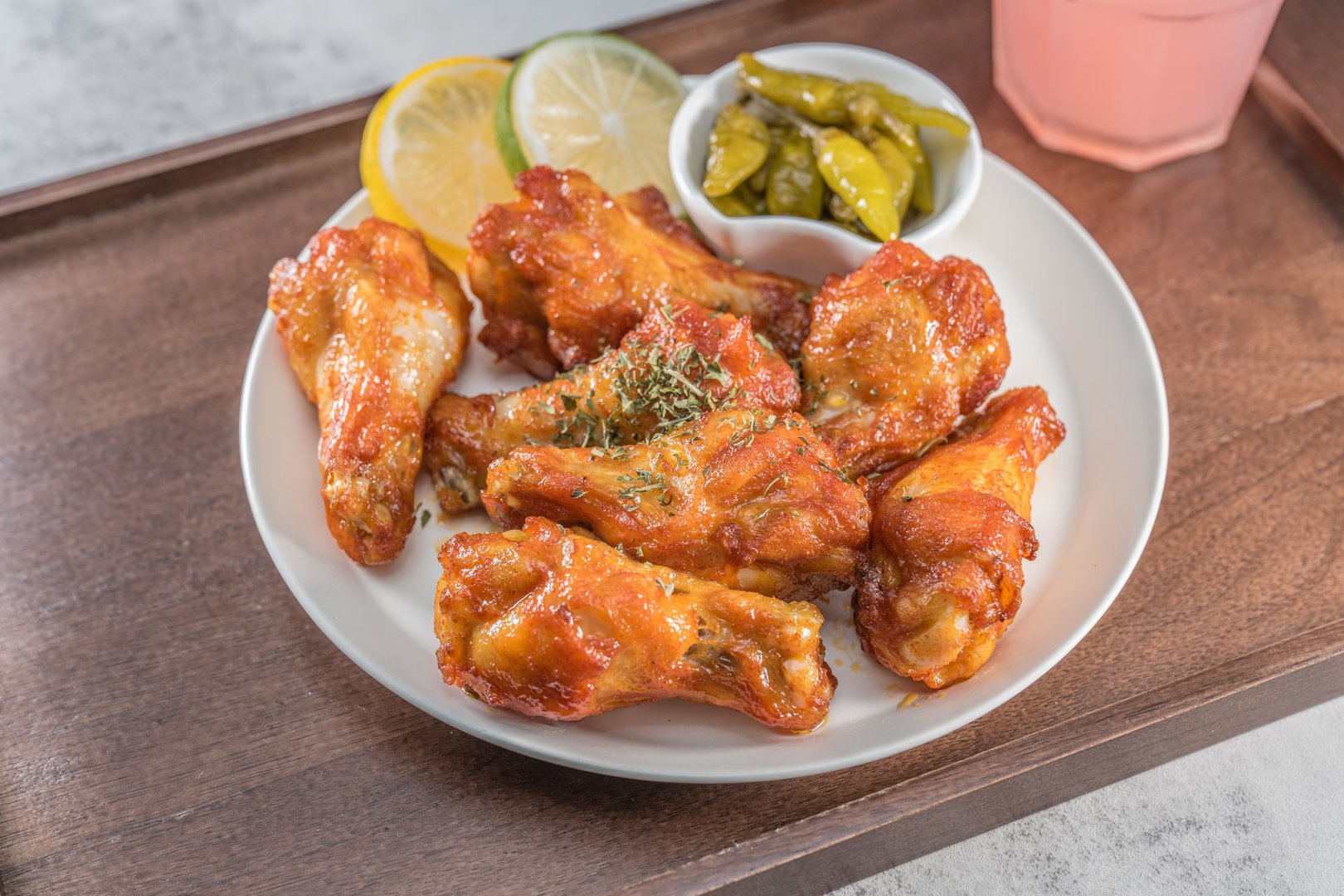 Savor the irresistible allure of these delicious, spicy buffalo chicken wings. Crispy, cooked to perfection and coated in a flavorful sauce, they are sprinkled with sesame seeds