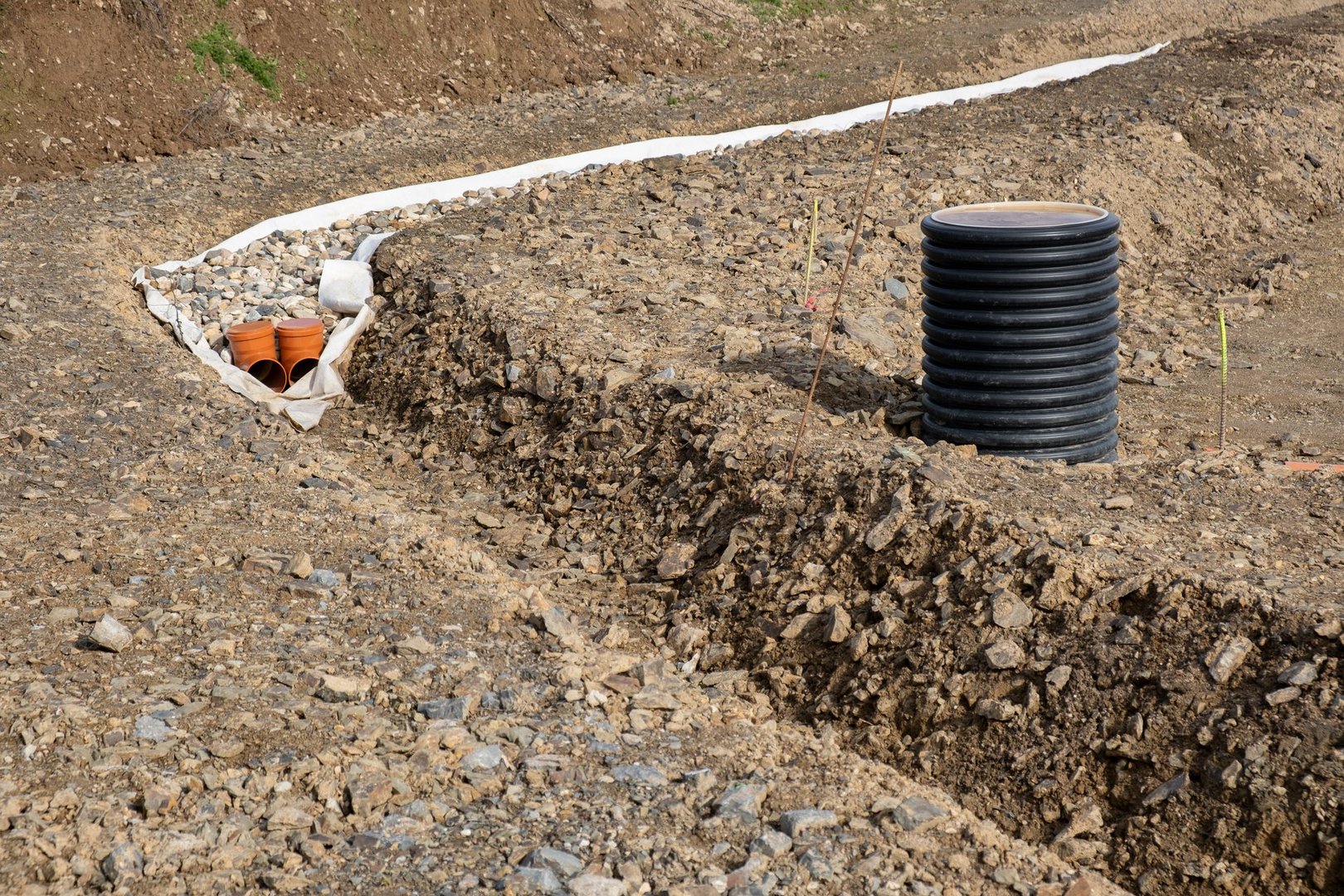 Digging a plumber canal as preparation for infrastructure on a construction site.