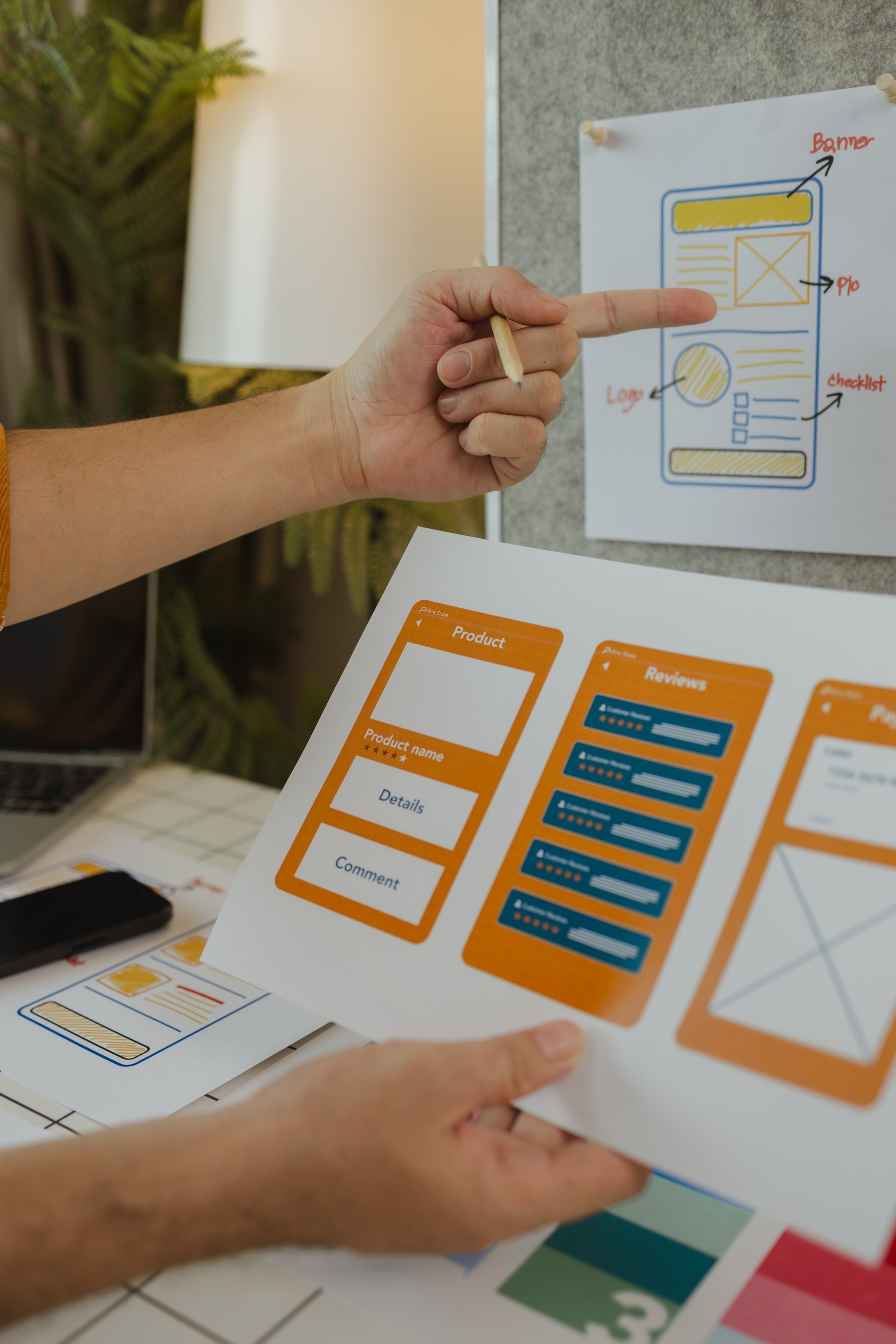 A web designer is using his idea to create a digital product design project that will meet the needs of users in terms of both appearance and feel when using it, ux, ui, interface, experience.