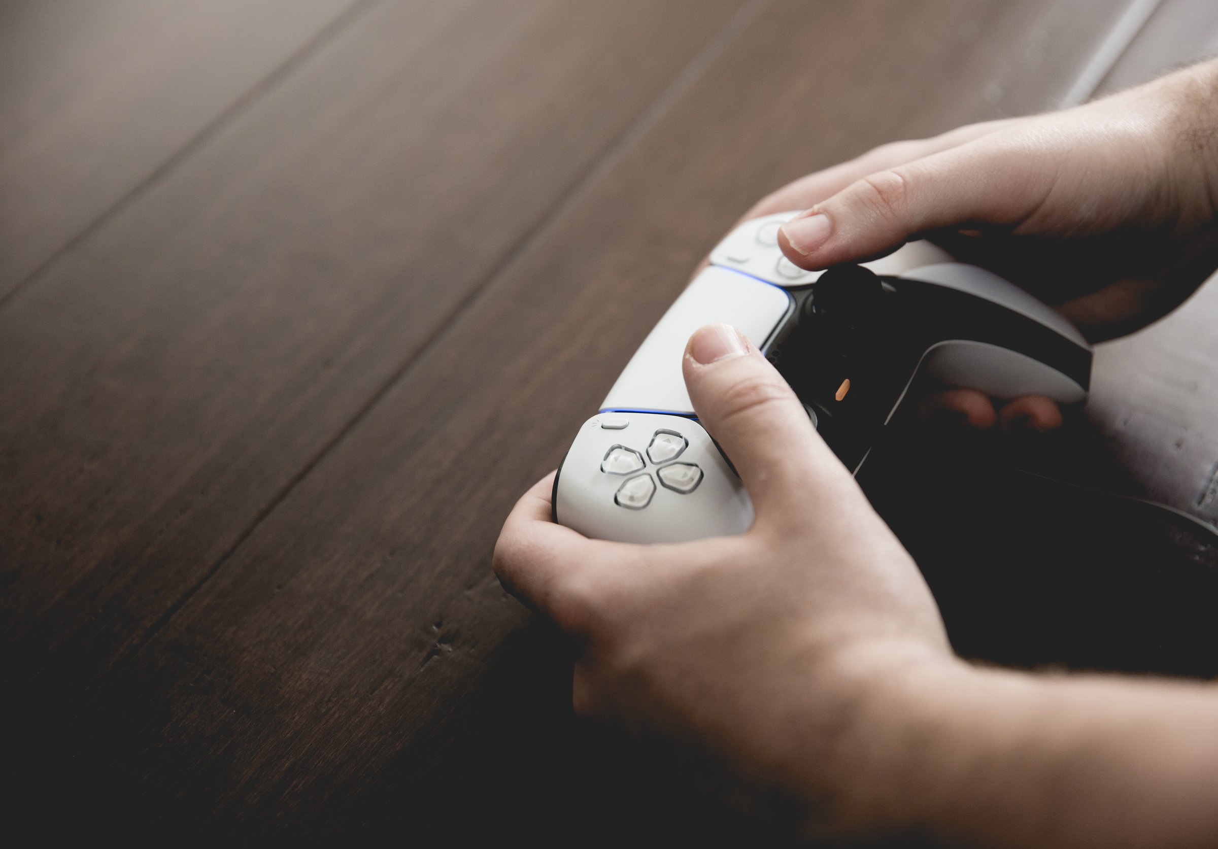 Selby, UK, March 11, 2021.  Close up of a pair of male hands using and playing with a Playstation  5 PS5 controller handset with copy space