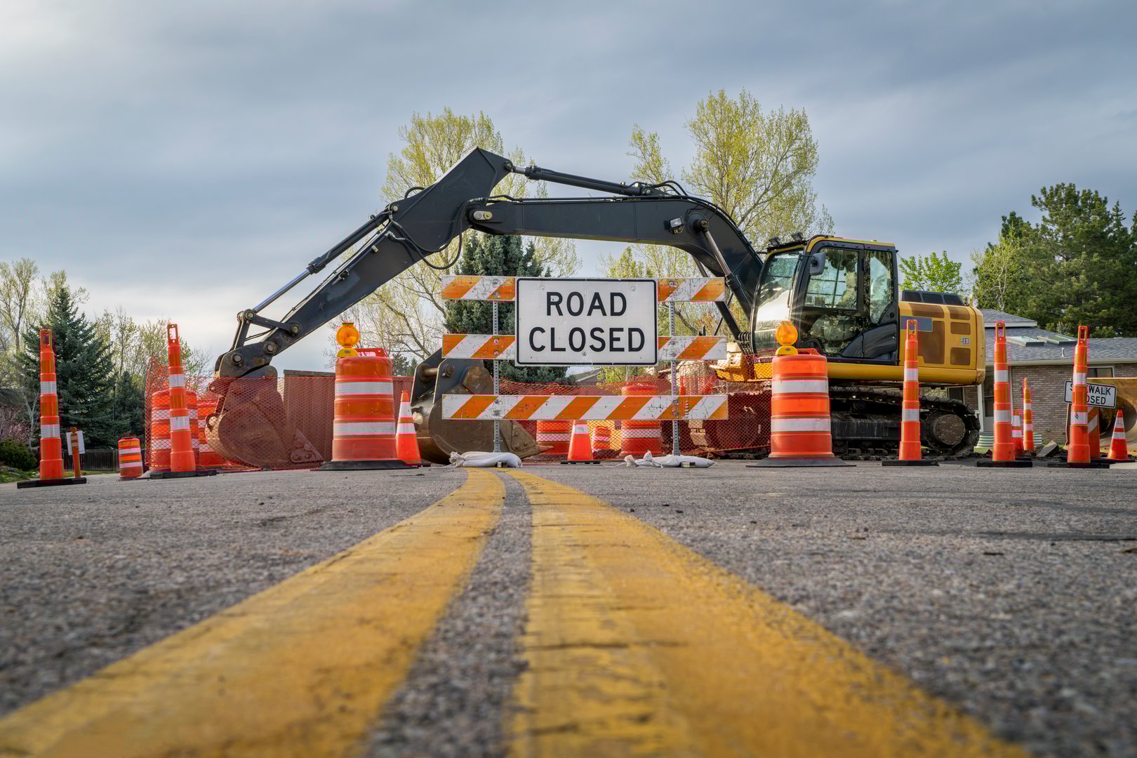 road closed - sign and barrier on a residential street for construction