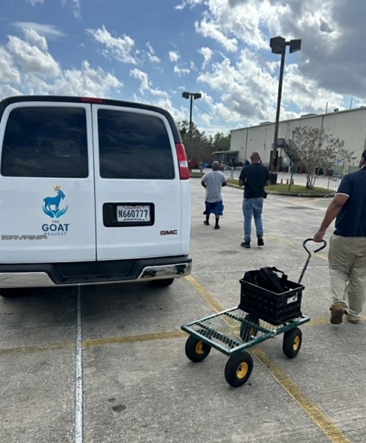 GOAT Project team escorting clients to local food bank