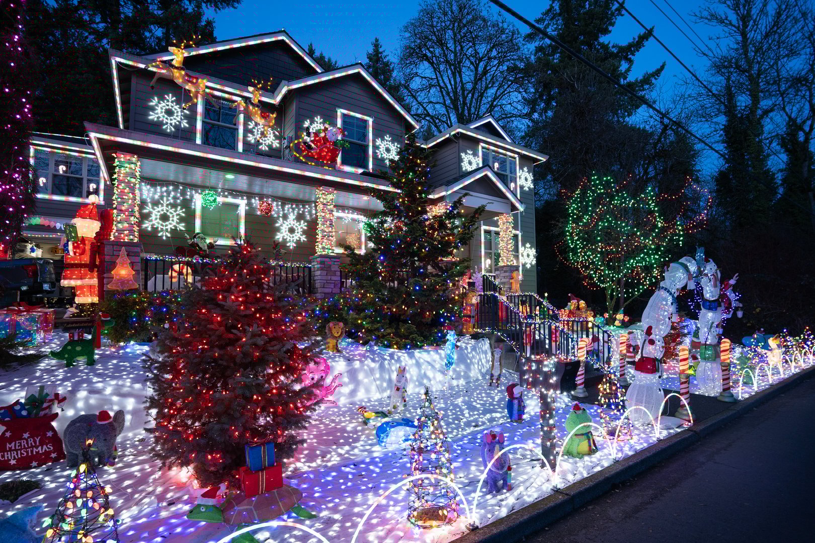 Lake Oswego, OR, USA - Dec 15, 2023: Colorful Christmas decorations in the front yard of a Lake Oswego home in the suburb of the Portland metro area in Oregon in the evening during the holiday season.