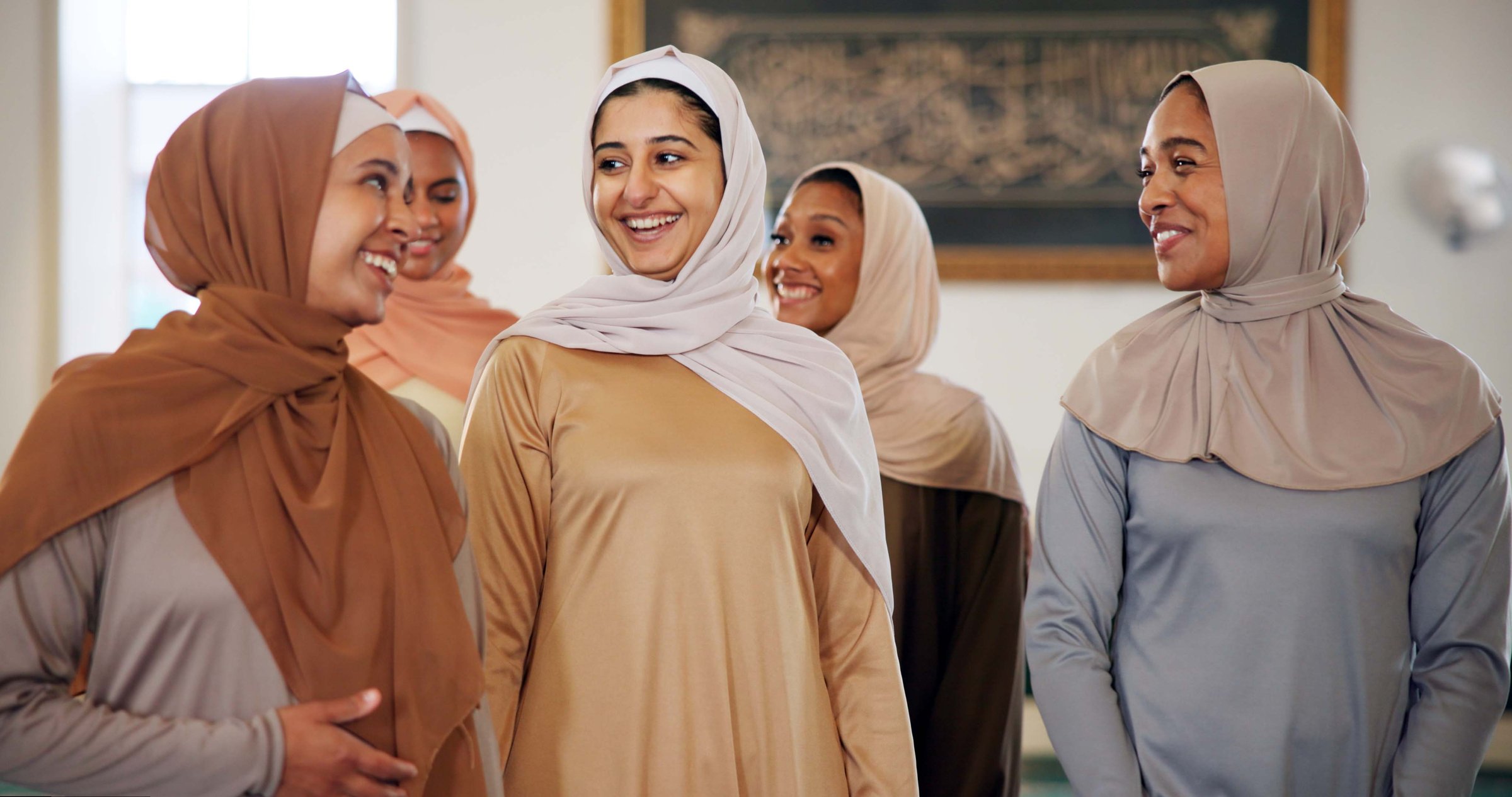 Smile, talking or Muslim woman in mosque to worship for gratitude or support to Allah. Happy, Islamic faith and spiritual people in conversation for God on Ramadan for learning together