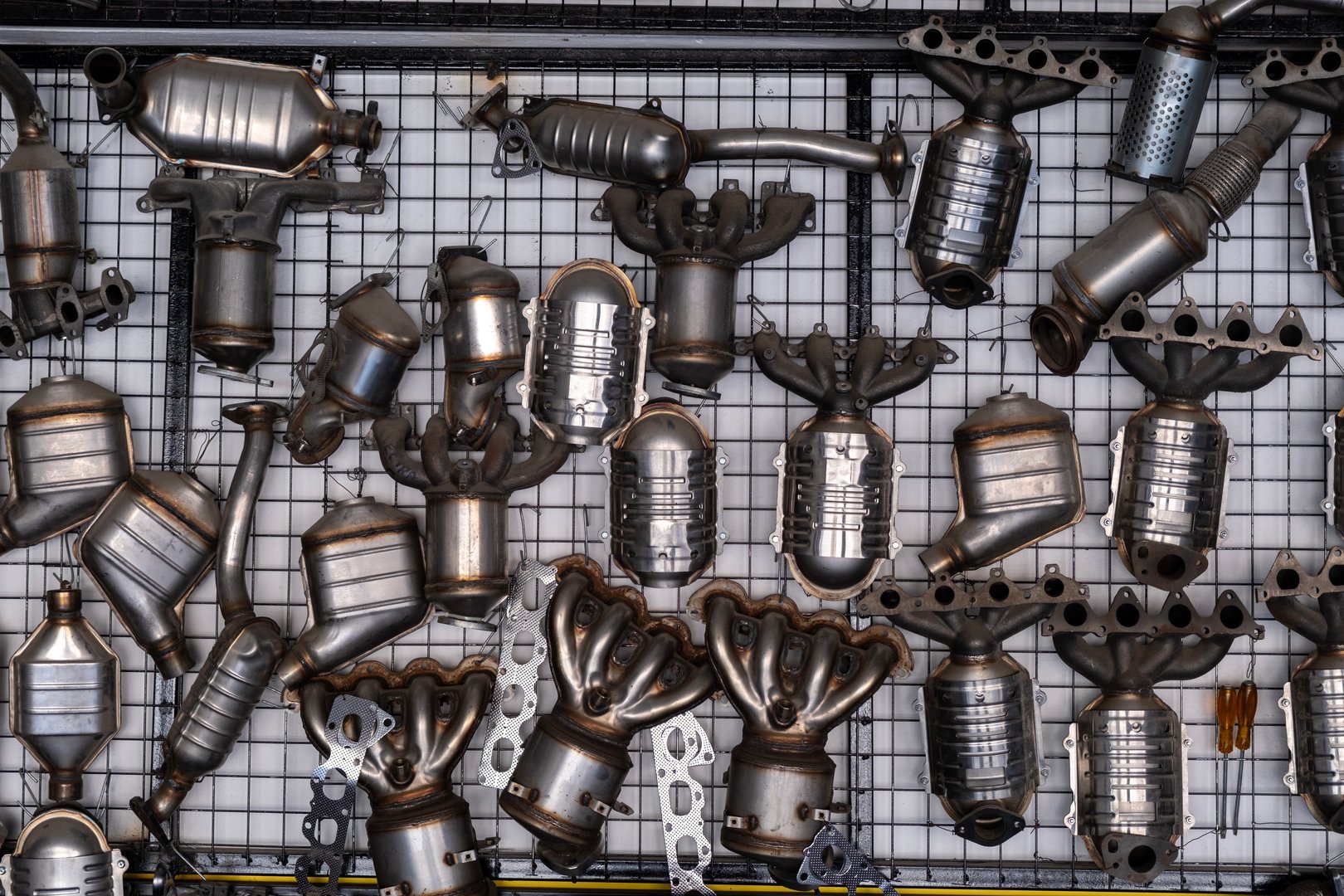 Car exhaust and manifold hanging on the wall