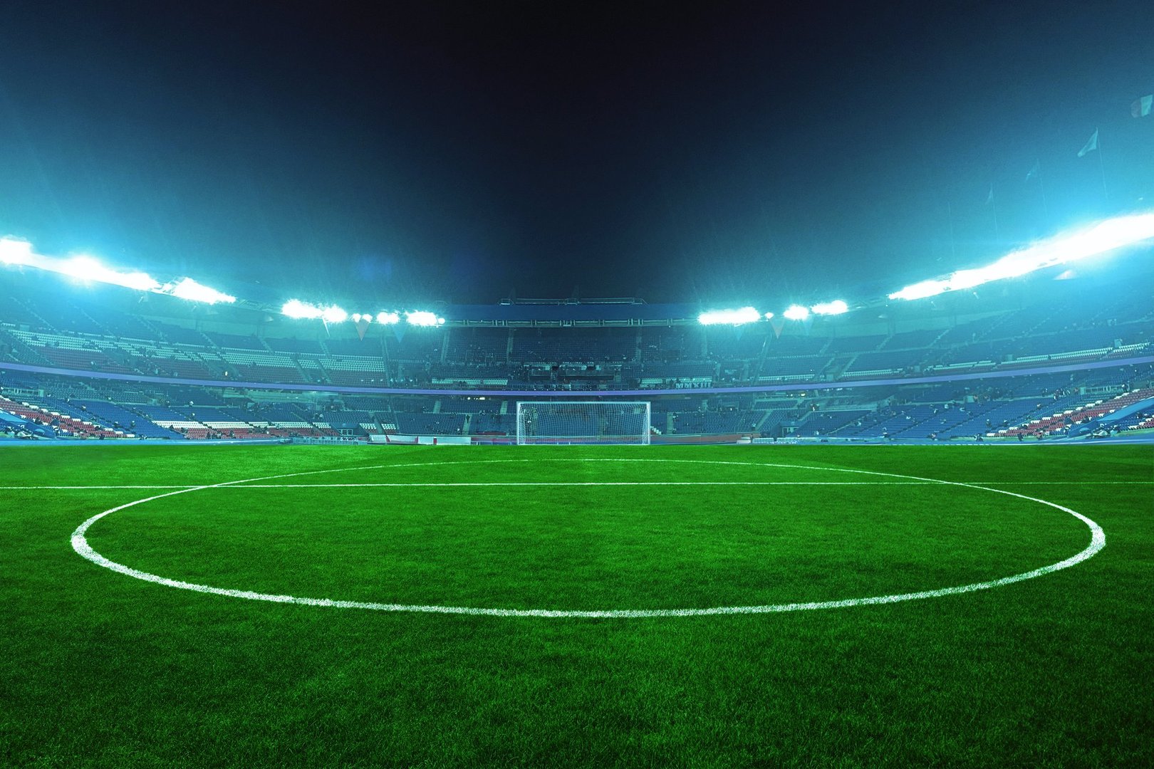 Estadio de fútbol iluminado de noche - campo verde bajo luces azules