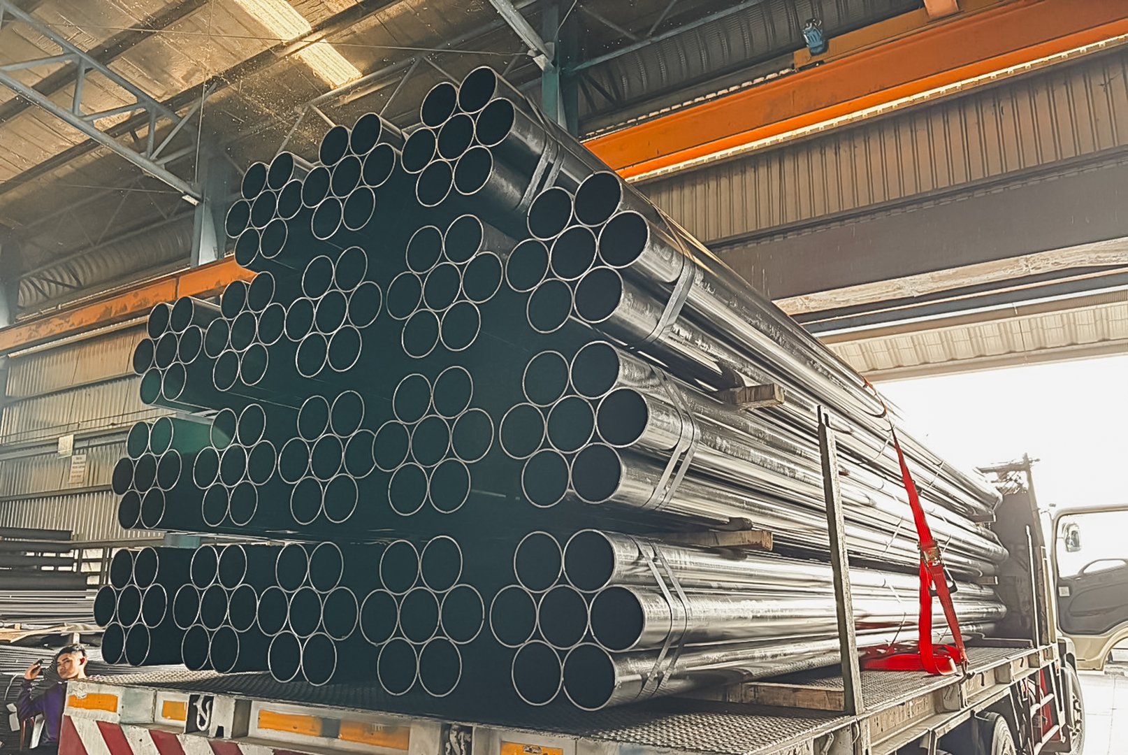 Construction products on transport vehicles Group of steel pipes for industrial materials Construction engineering products  equipment, steel pipes, metal warehouse industry, delivery to customers