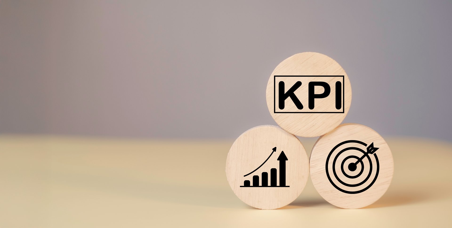 KPI Measurement for Business Success key Indicators to Track Goals and Performance on wood label. Marketing strategies, realistic objectives, and controlled planning for optimal results.