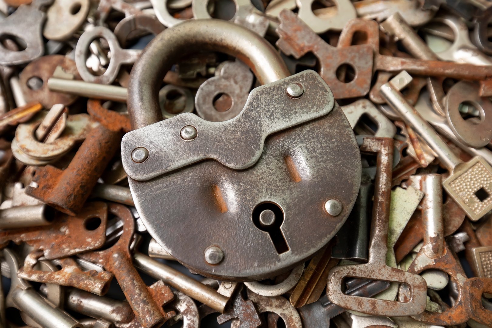 Old big metal padlock with many keys, abstract security photo