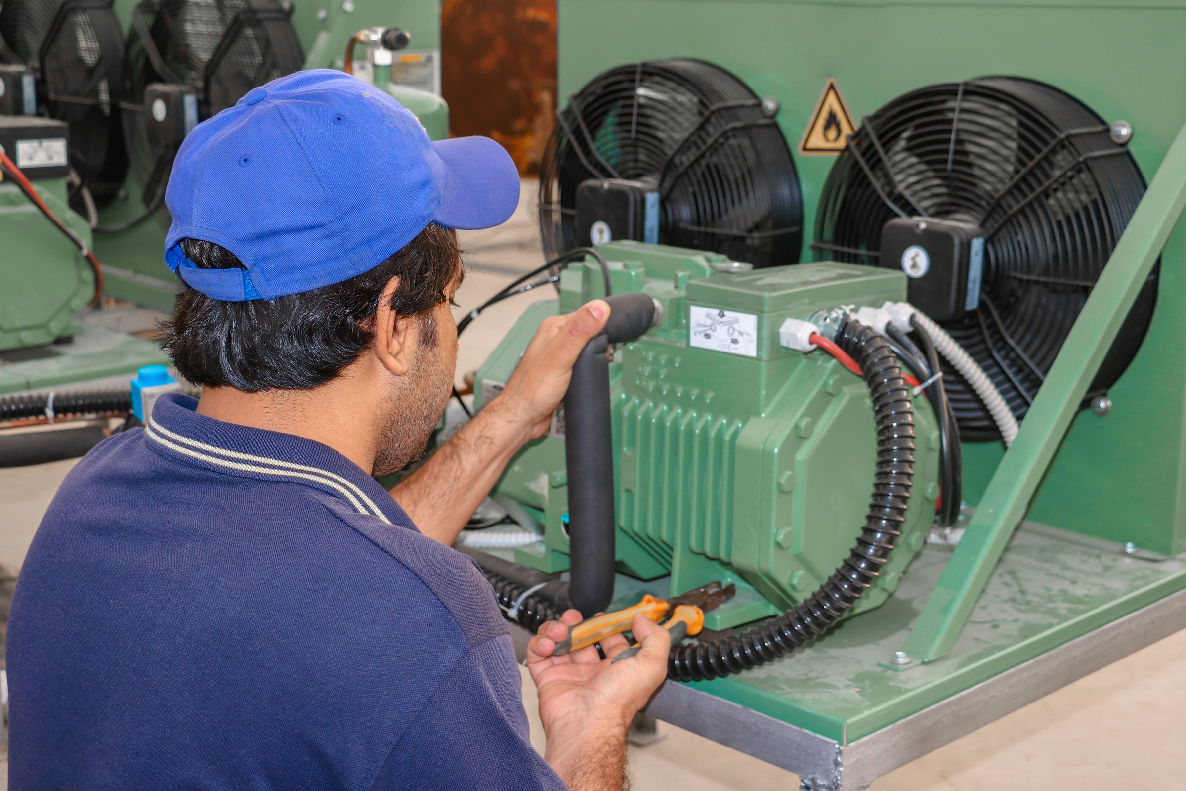 Technician repairing commercial refrigeration